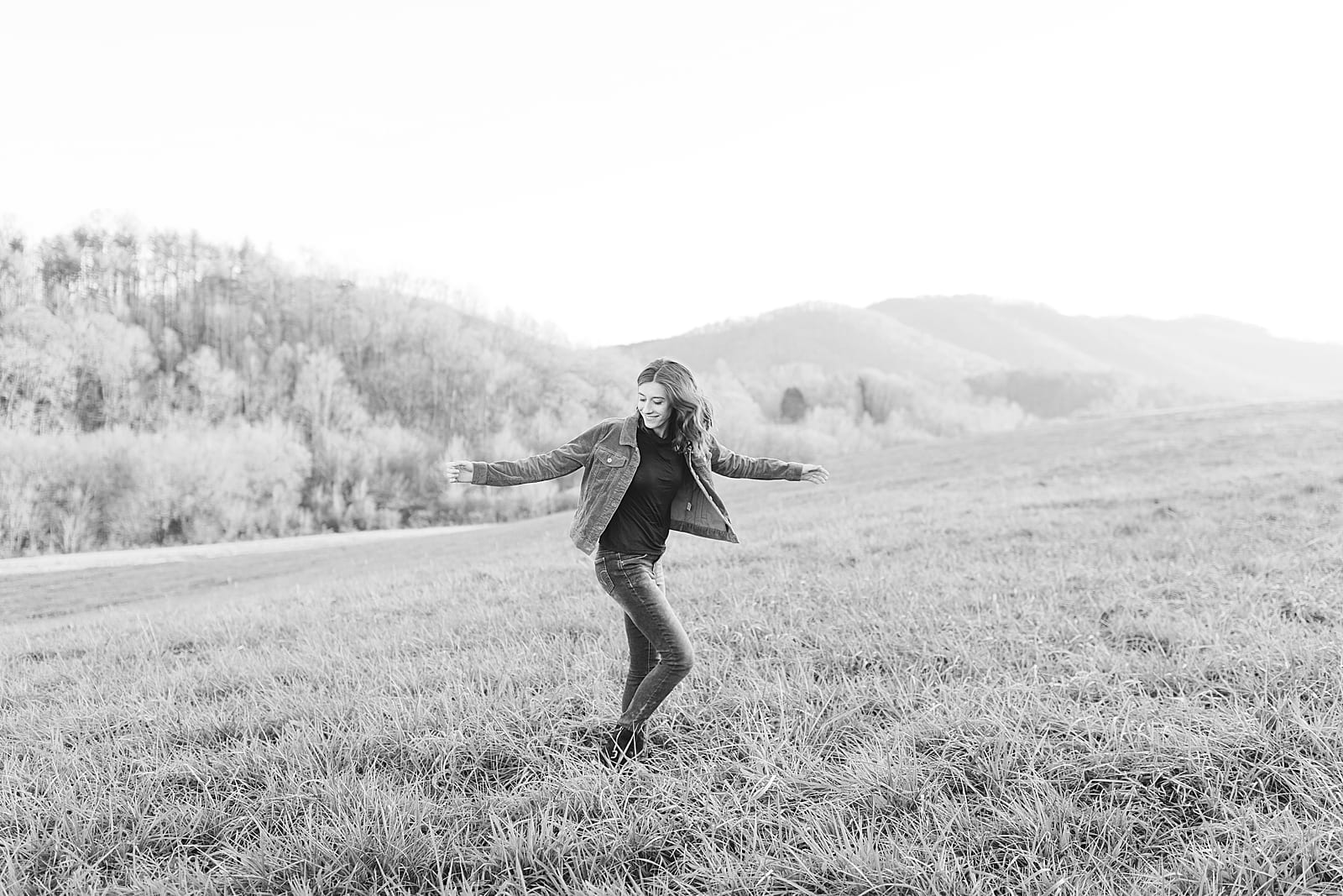 Black and White of Girls Spinning In Field Photo