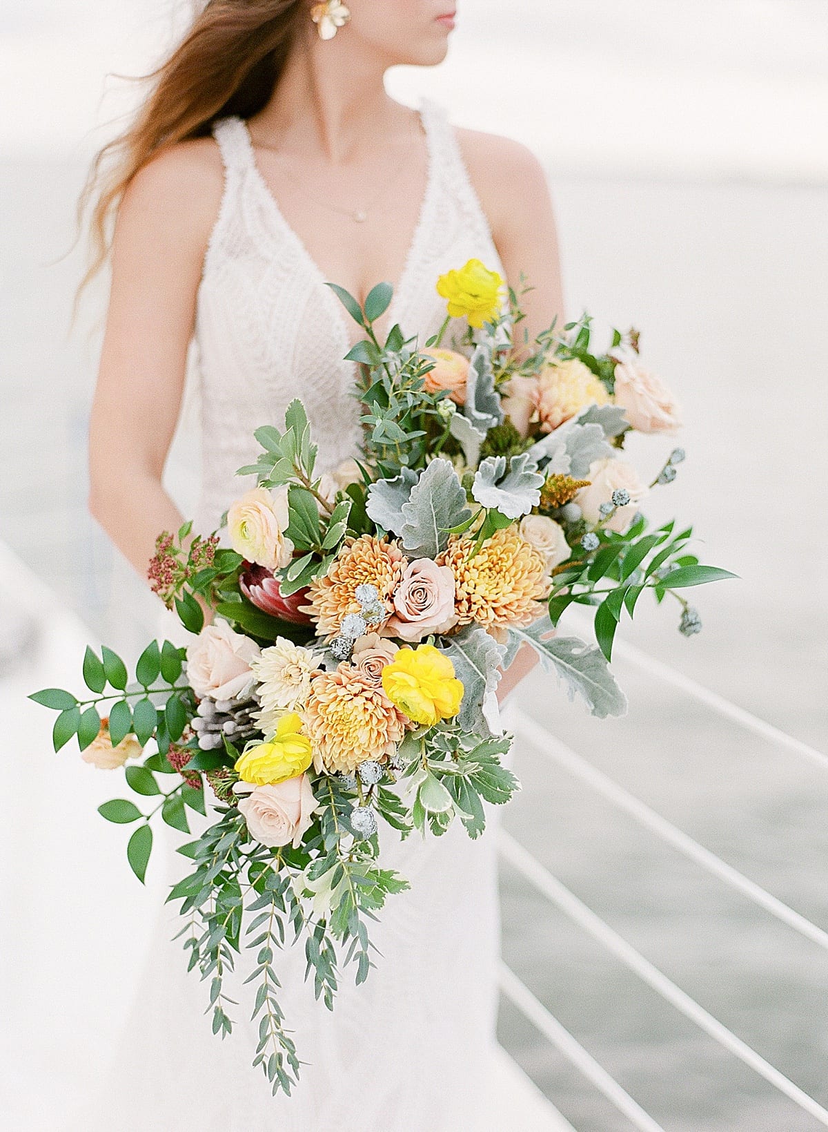 Detail of Bride Holding Fall Colored Bouquet Photo