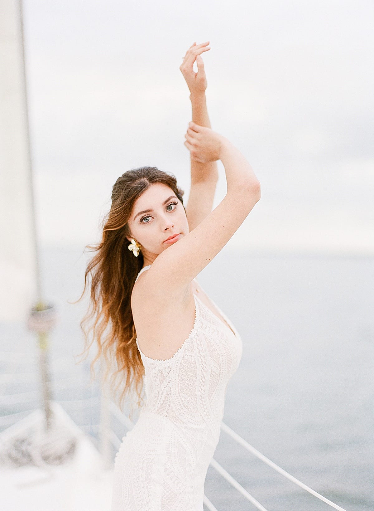 Bride on Sailboat with arms over her head Photo