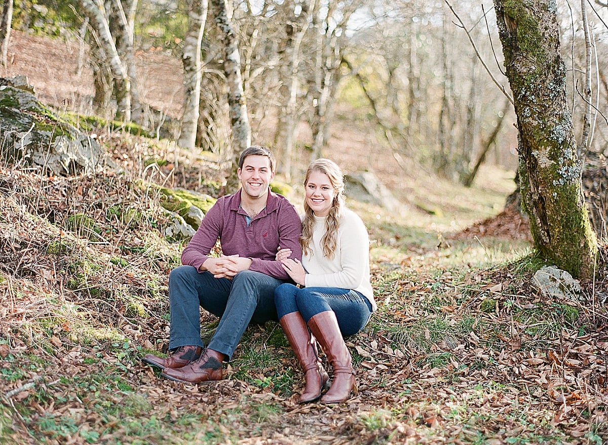 Couple Sitting on Ground Smiling at Camera Photo