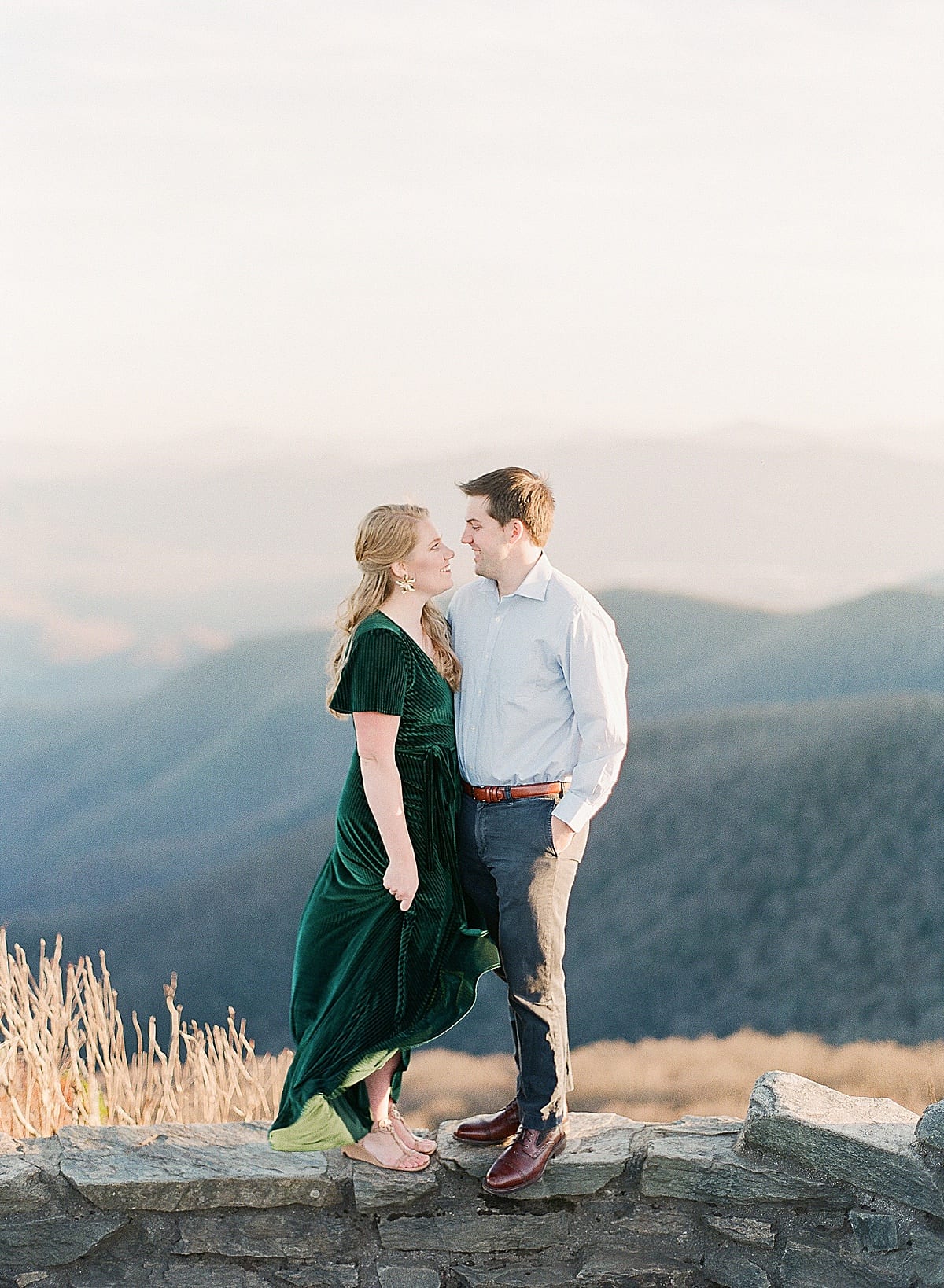 Mountaintop Engagement Session Couple Smiling at Each Other Photo