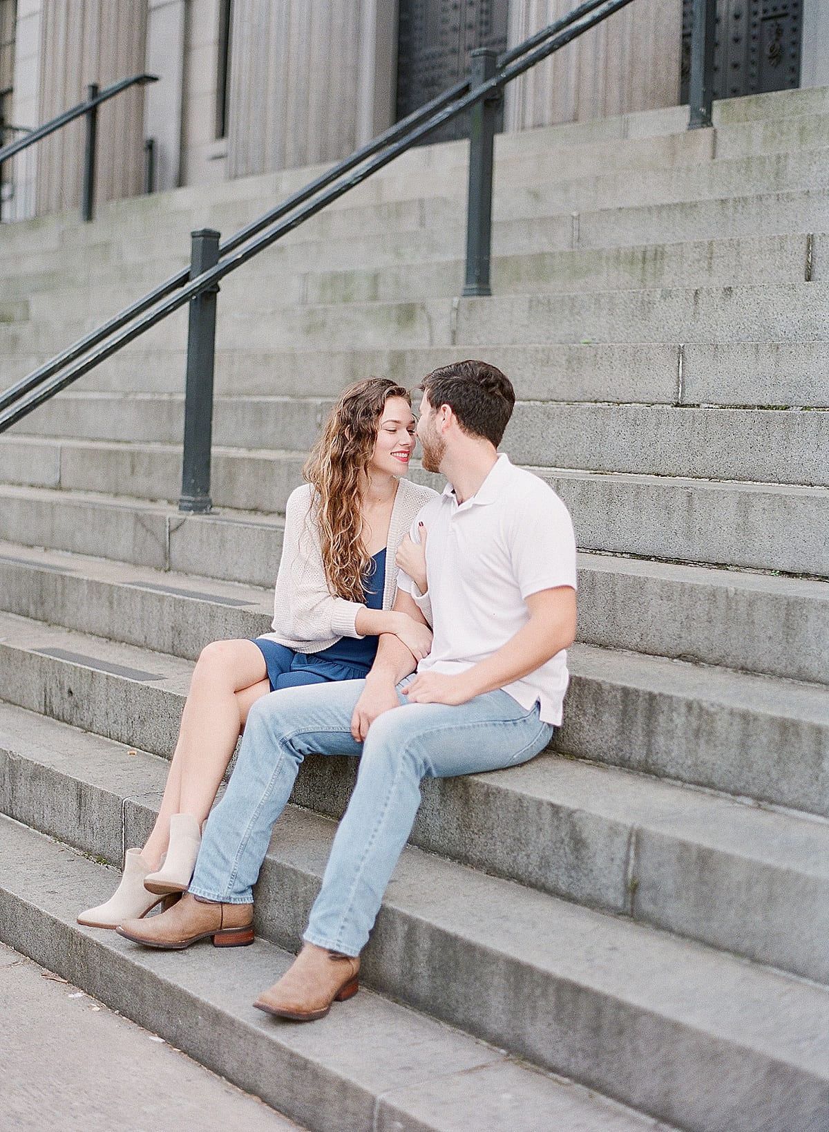 Couple Sitting on Stairs Snuggling Photo