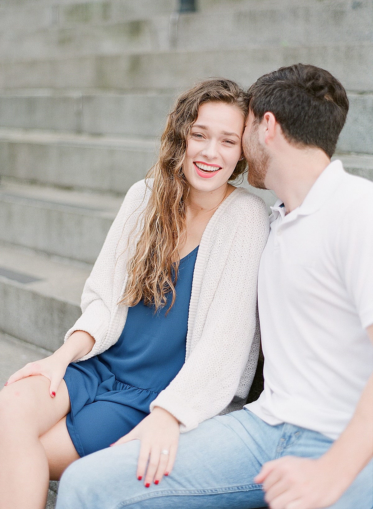 Couple Sitting on Stairs Laughing Photo