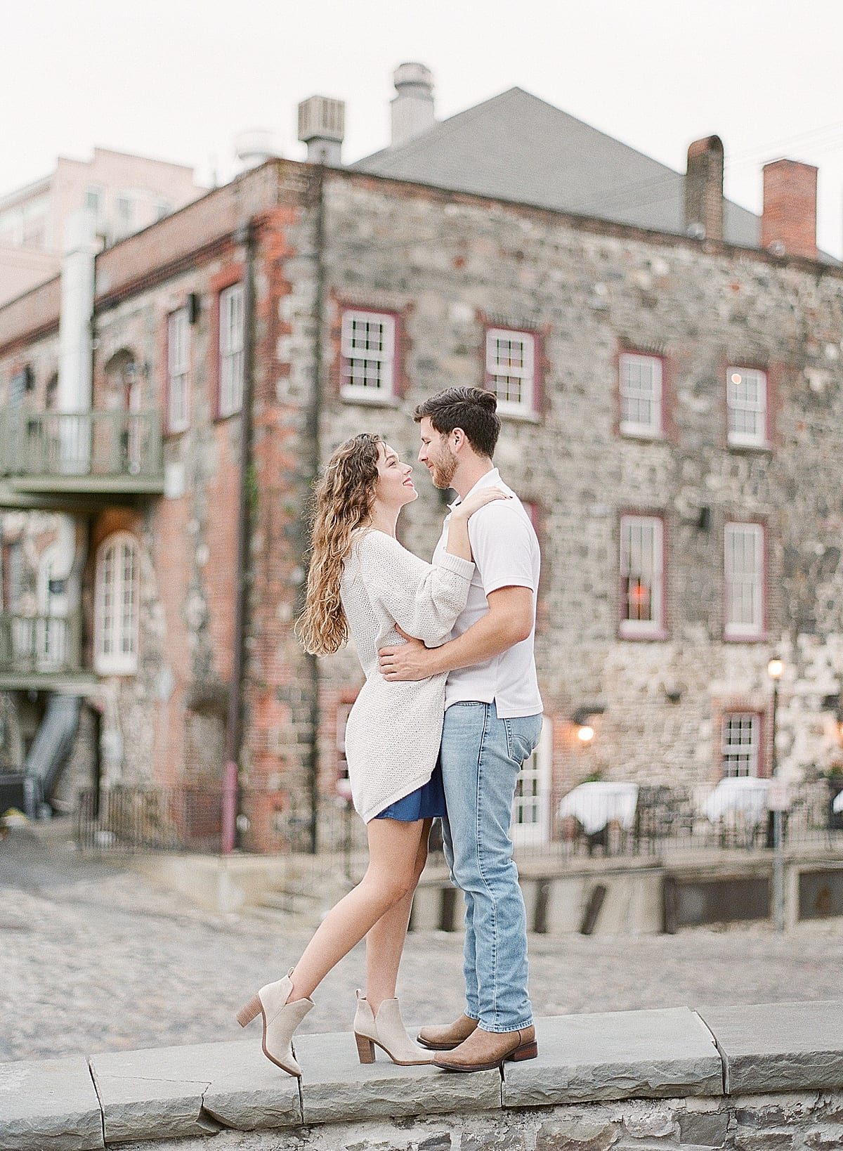 Couple on Wall Smiling at Each Other in Historic Savannah Photo