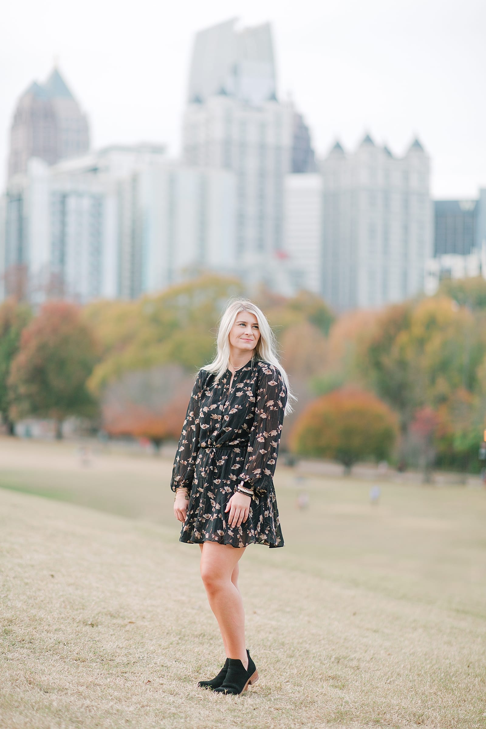 Cute Girl in Black Dress Looking off with Atlanta Skyline in Background Photo