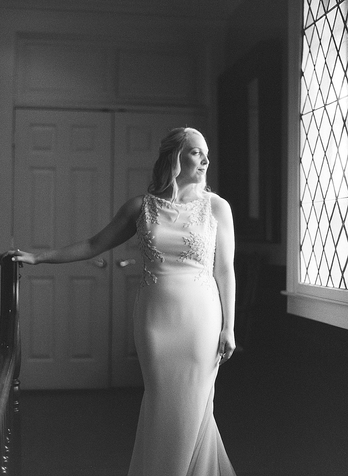 Black and White of Bride Looking Out the Window Photo