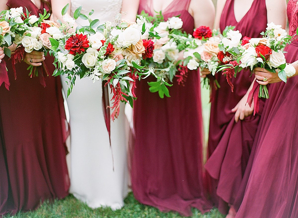 Detail of Bridal Party Bouquets and Bridesmaids in Burgundy Dresses Photo