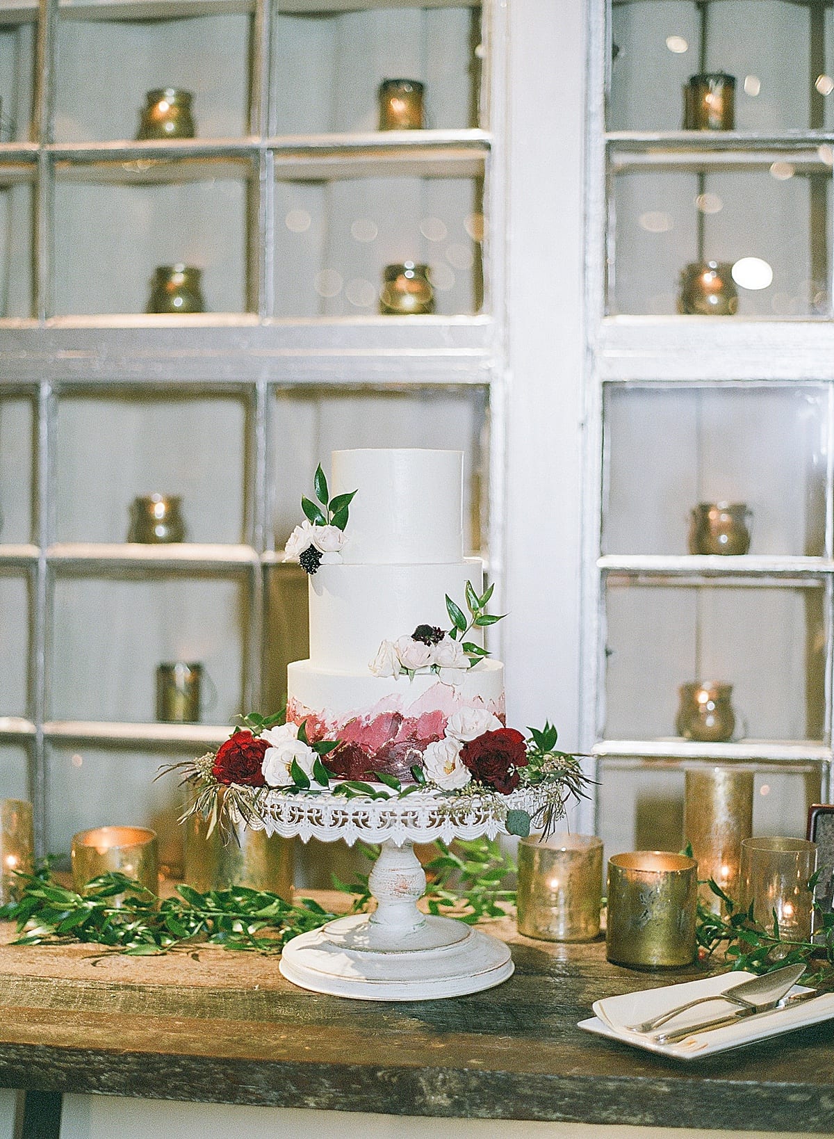 Wedding Cake on White Pedestal With Flowers Photo