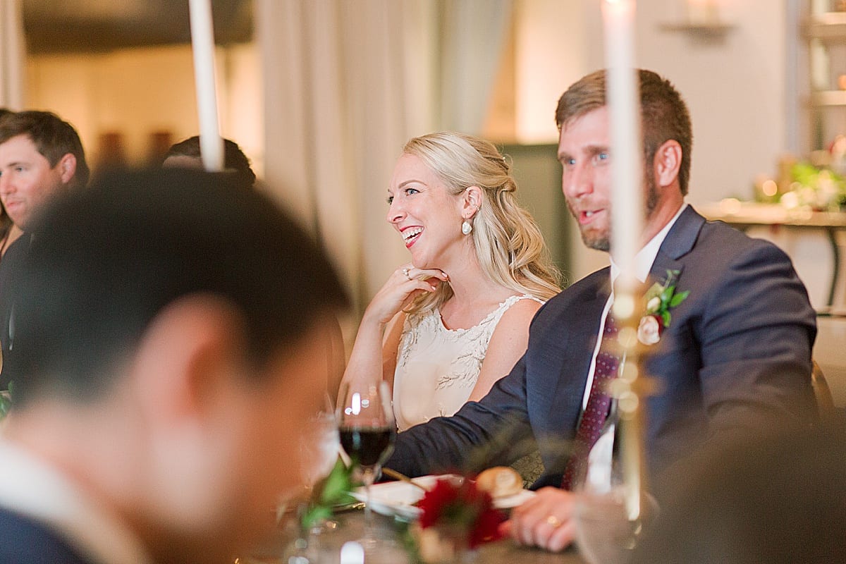 Bride and Groom Smiling During Reception Toast Speeches Photo