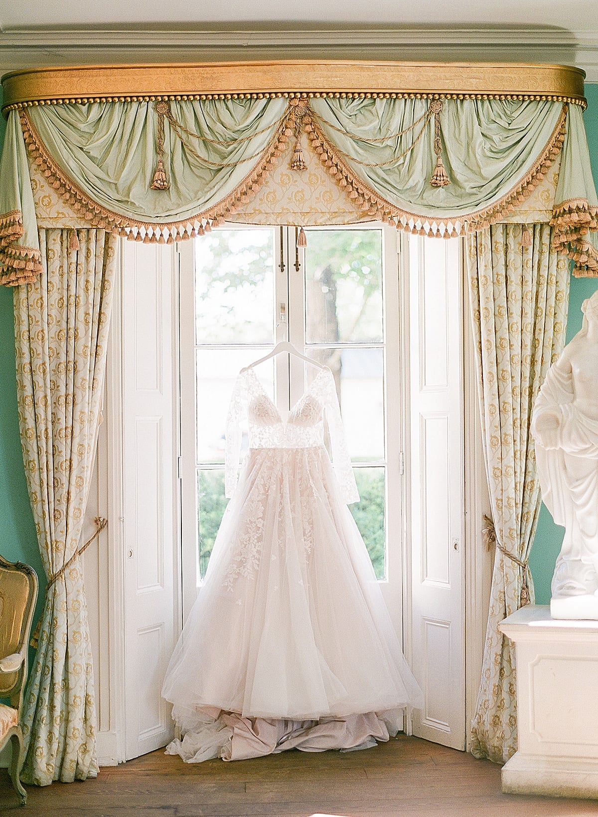 Bridal Gown Hanging in Window Photo