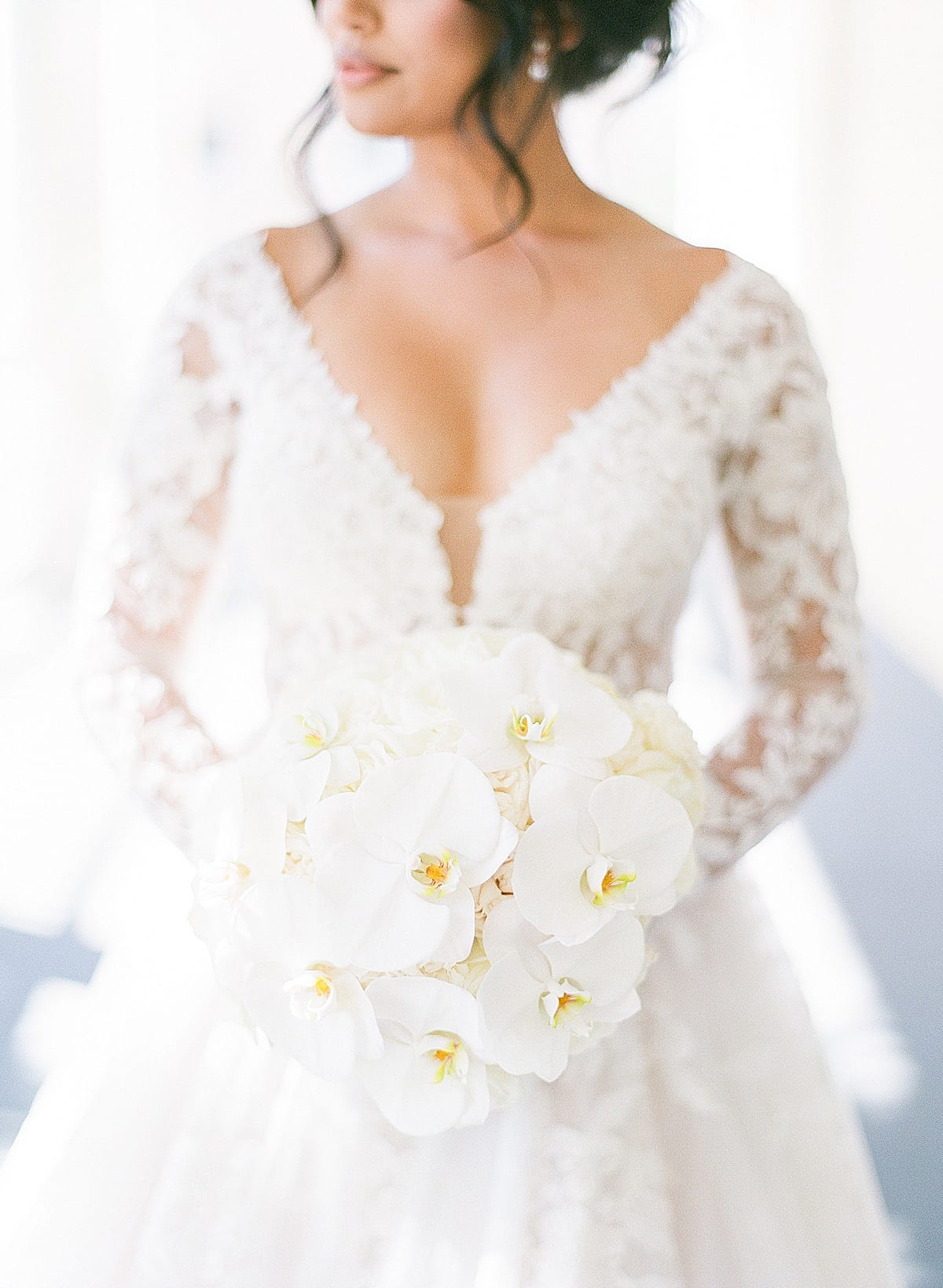 Detail of Bride Holding Bouquet with Roses and Orchids Photo