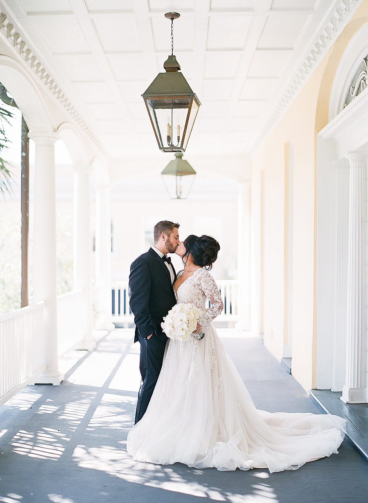 Bride and Groom Kissing on William Aiken House Porch Photo