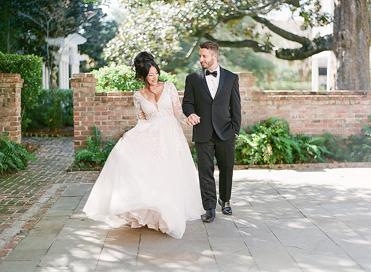 Bride and Groom Holding Hands Walking Toward Camera Photo
