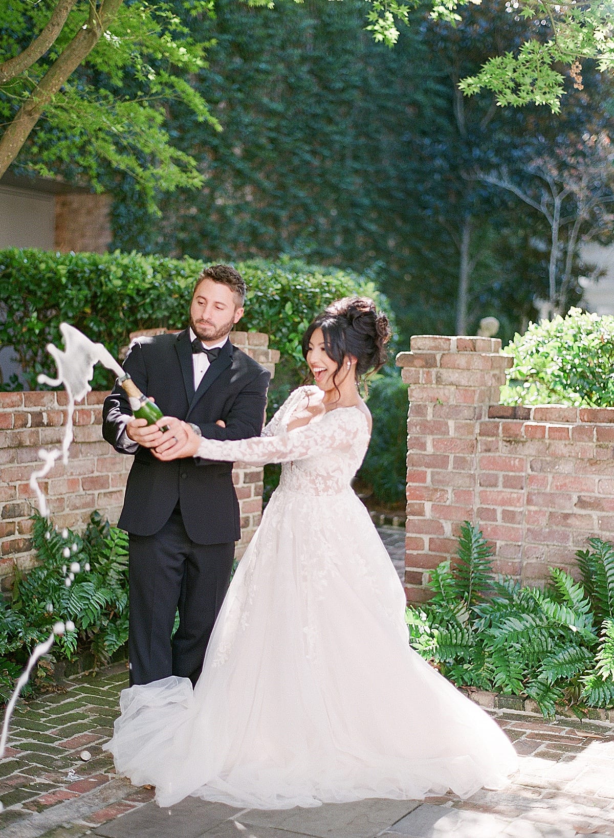 Bride and Groom Popping Champagne Photo