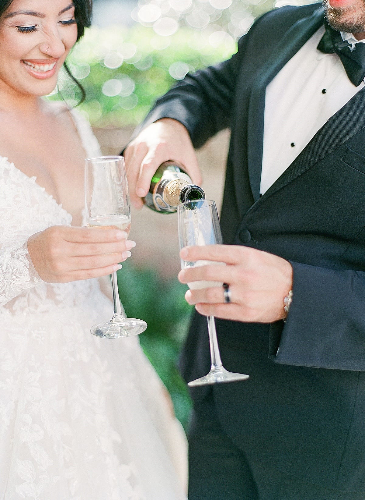 Bride and Groom Pouring Champagne Photo