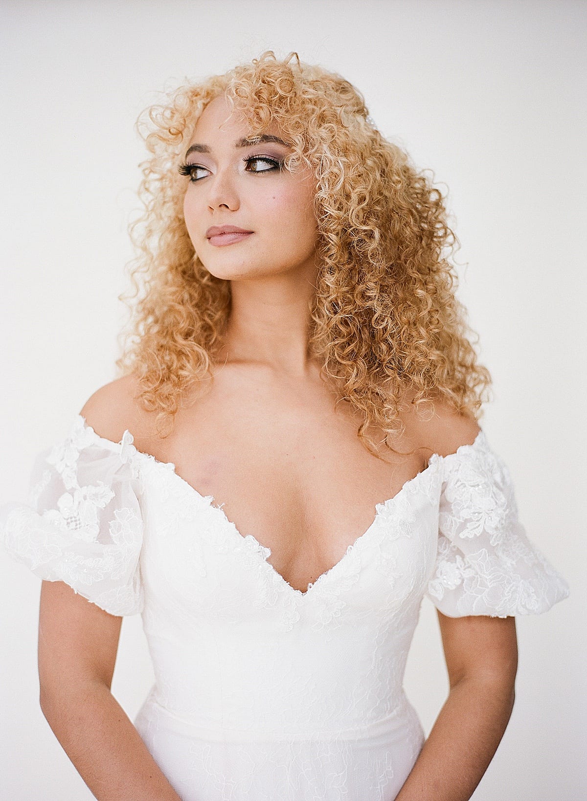 Bride with Curly Hair Looking Off Photo 