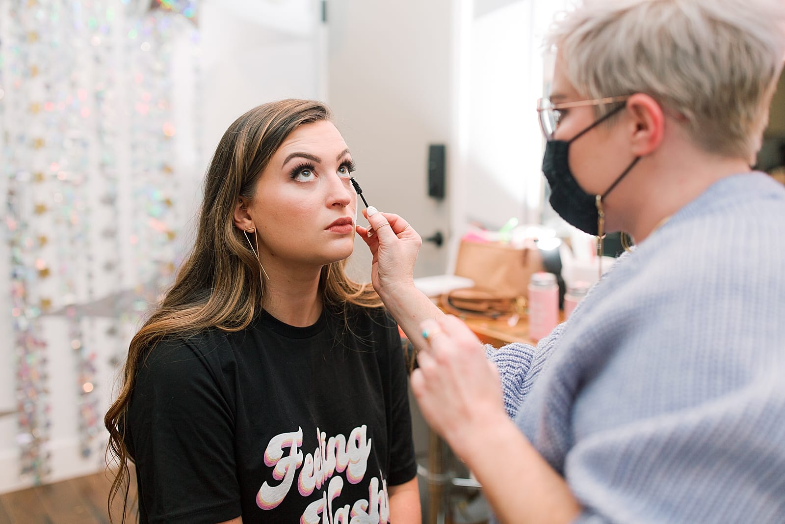 Bridesmaid getting her makeup done photo