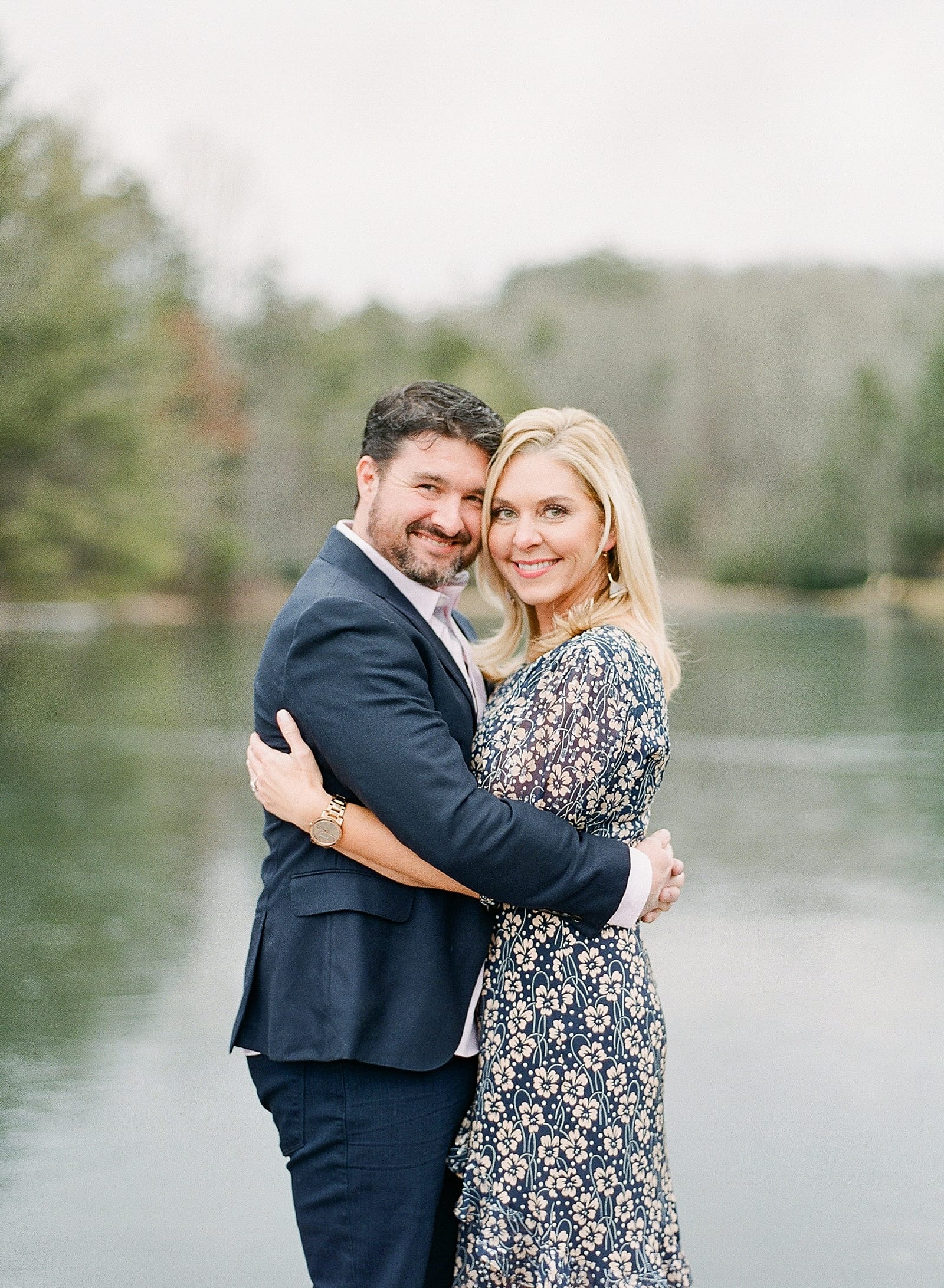 Couple Hugging Smiling at Camera on a Dock Photo