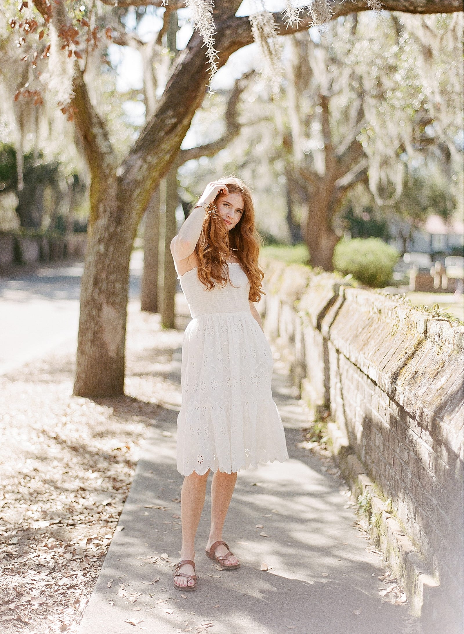 Girl in White Dress on Sidewalk Photo