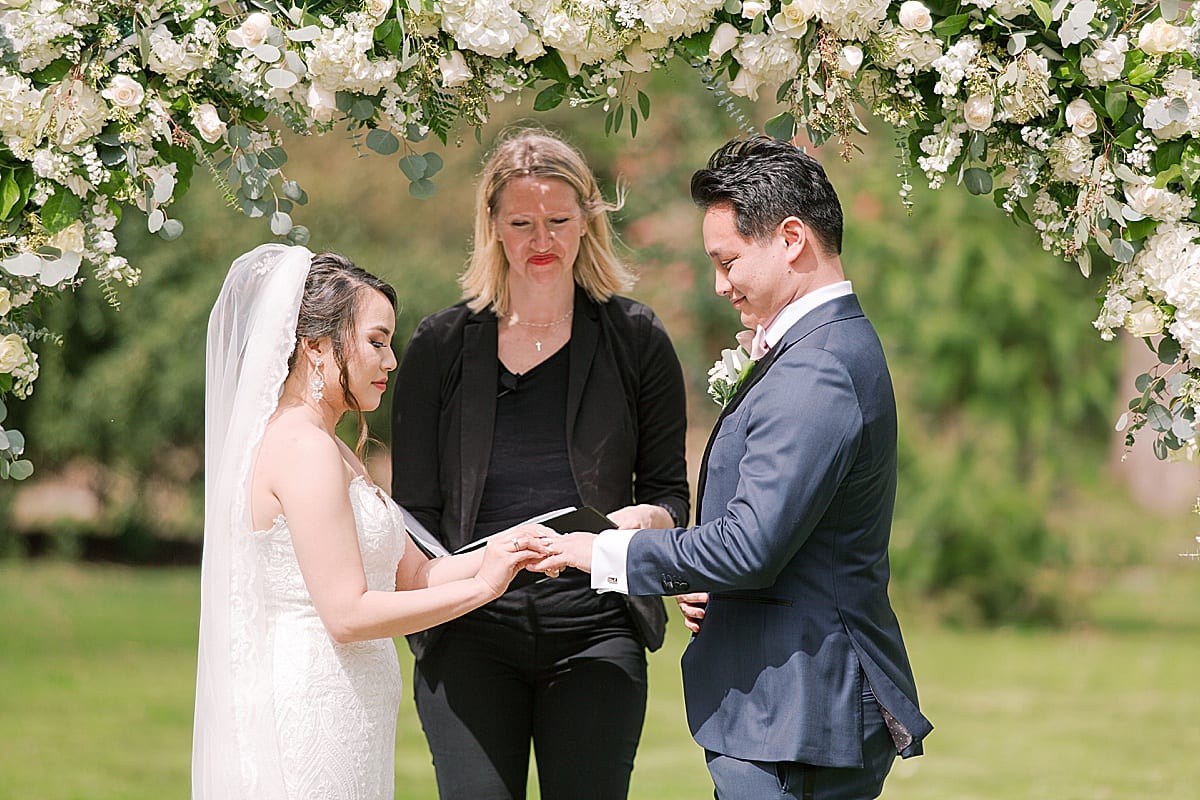 Cator Woolford Gardens Bride and Groom Exchanging Rings During Ceremony Photo
