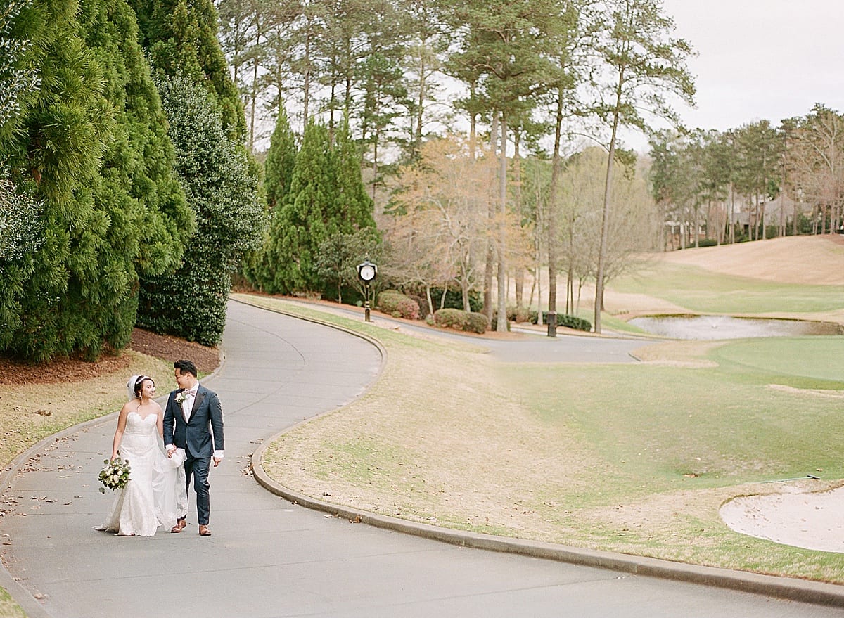 Country Club Of The South Bride and Groom Walking On Path Photo