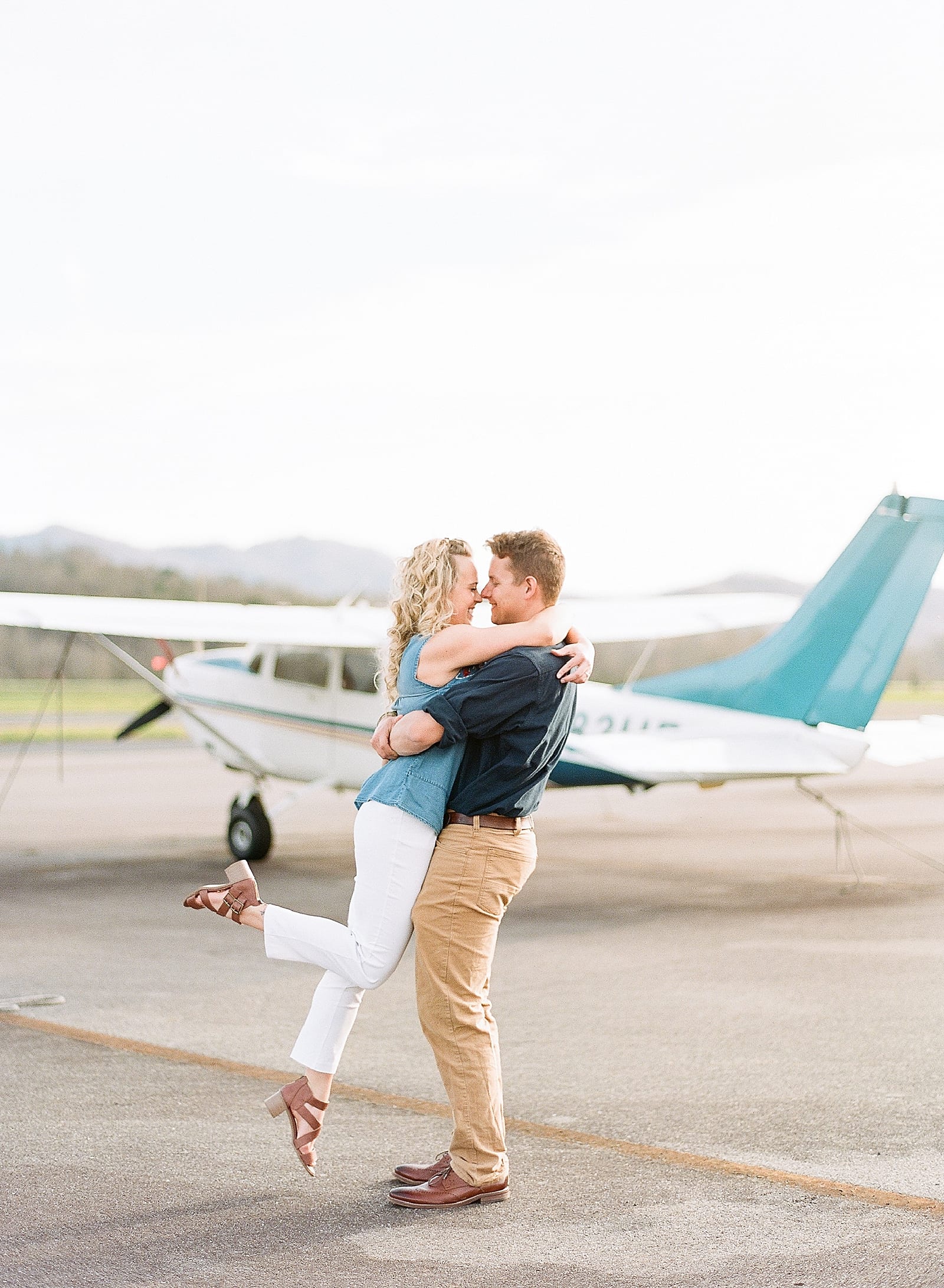 couple nose to nose spinning at local airport photo