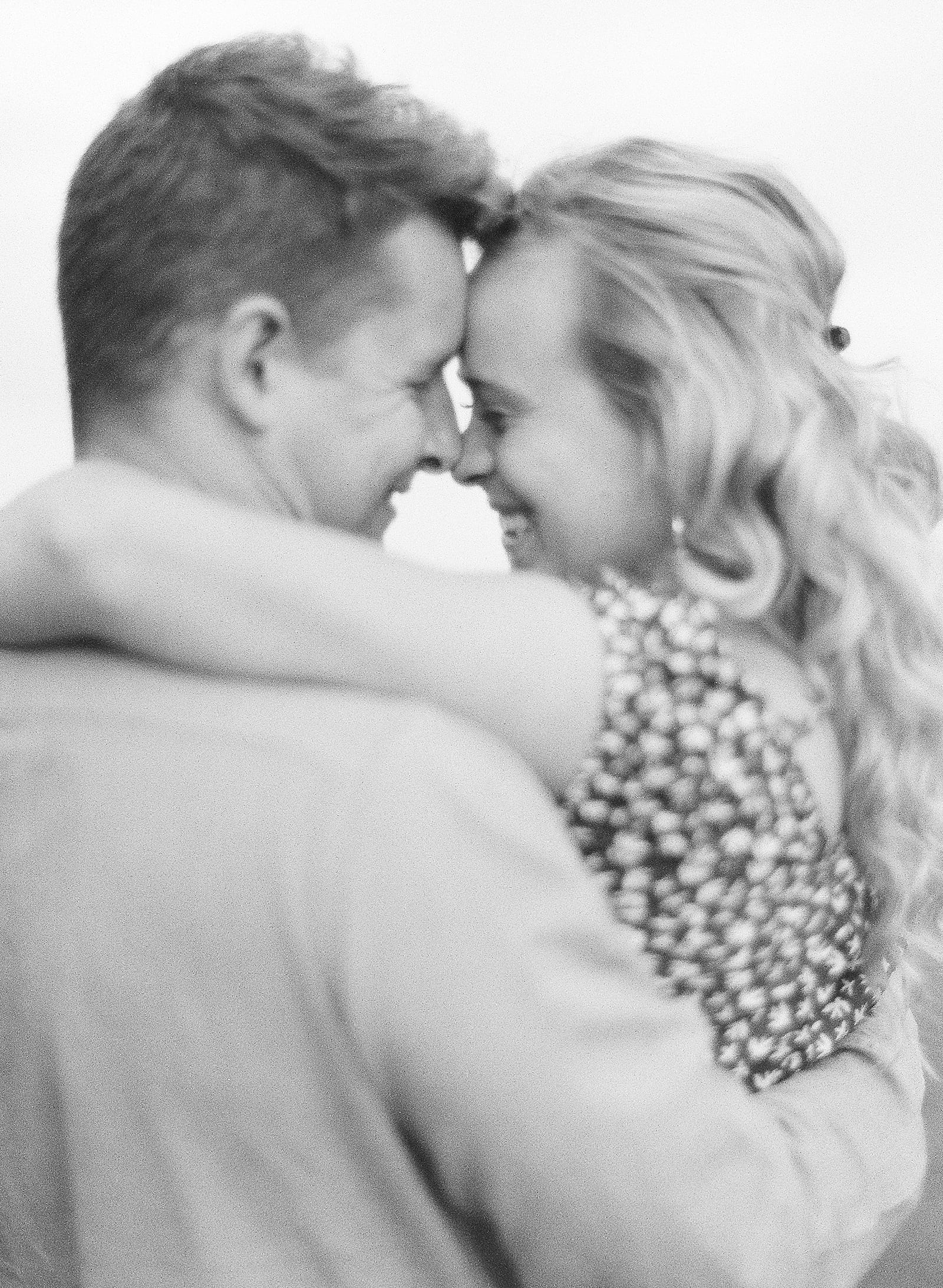 Black and white of couple hugging and giggling Photo