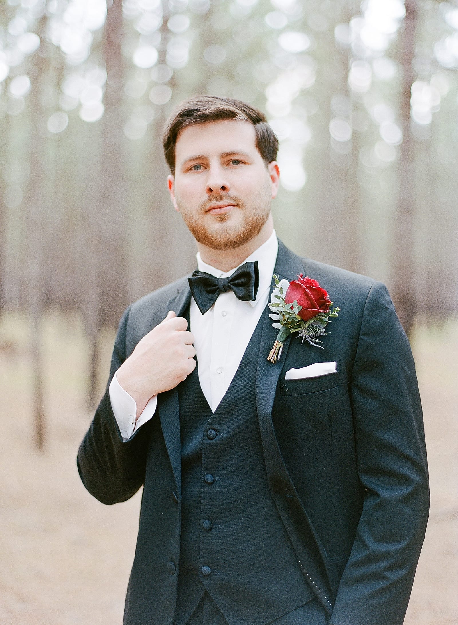Groom Holding Jacket Portrait Looking at Camera Photo