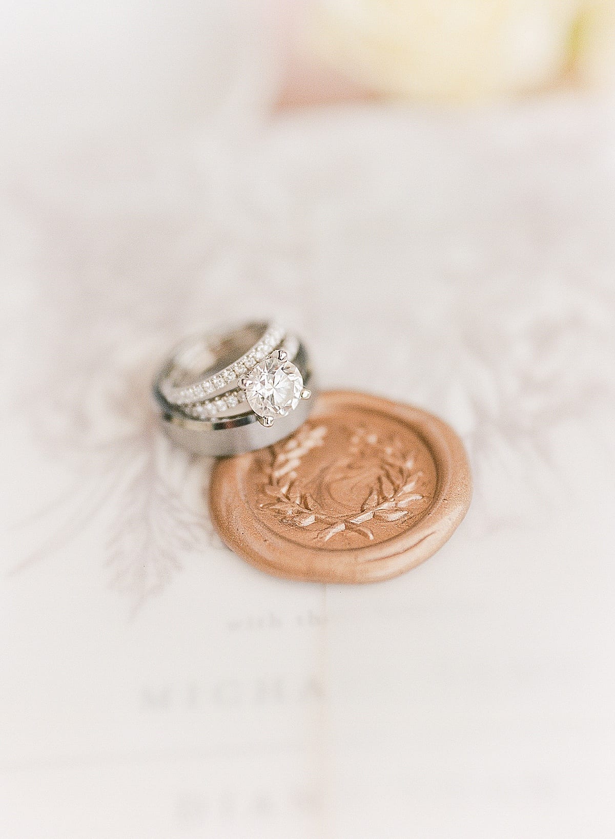 Wedding rings on wax seal on invitation suite photo