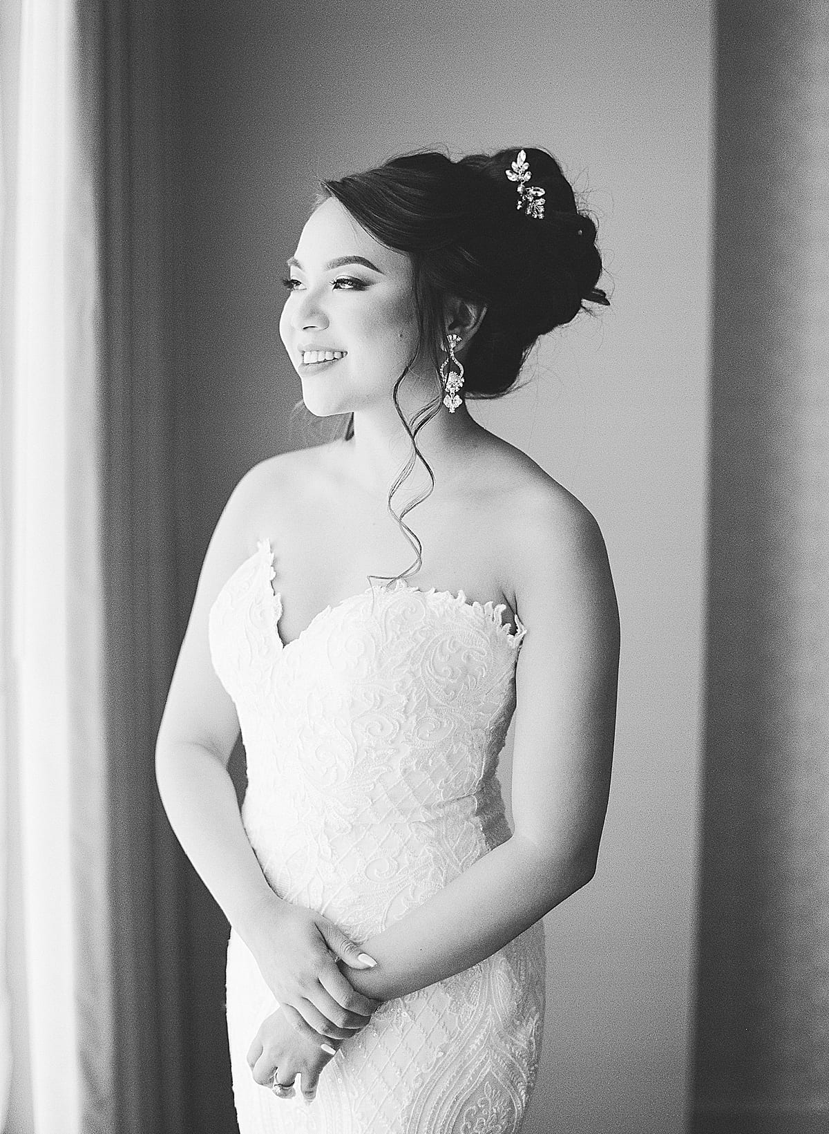 Black and White Of Bride Looking out Window photo