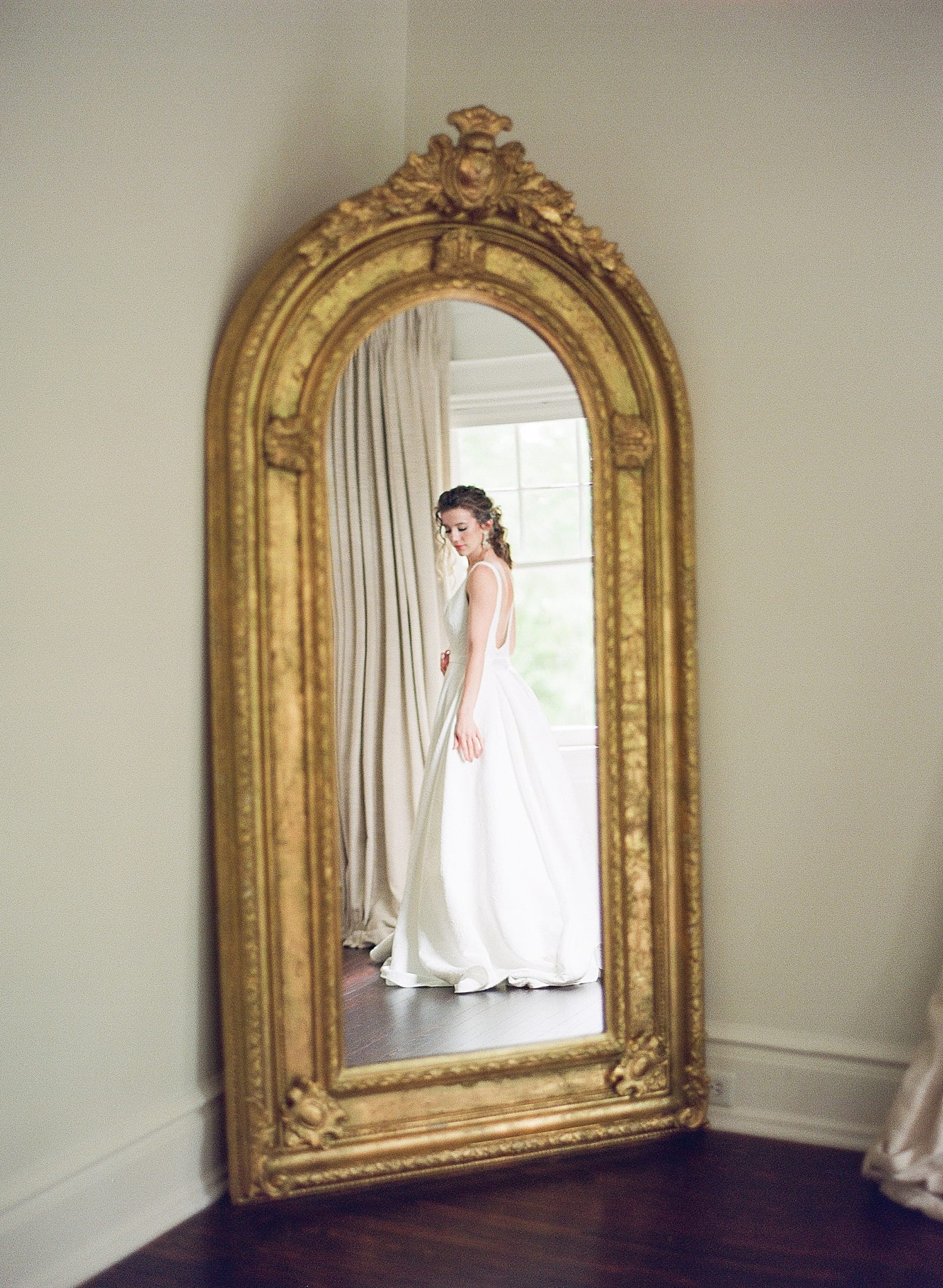 Bridal Portraits Bride Looking Down in Gold Mirror Photo