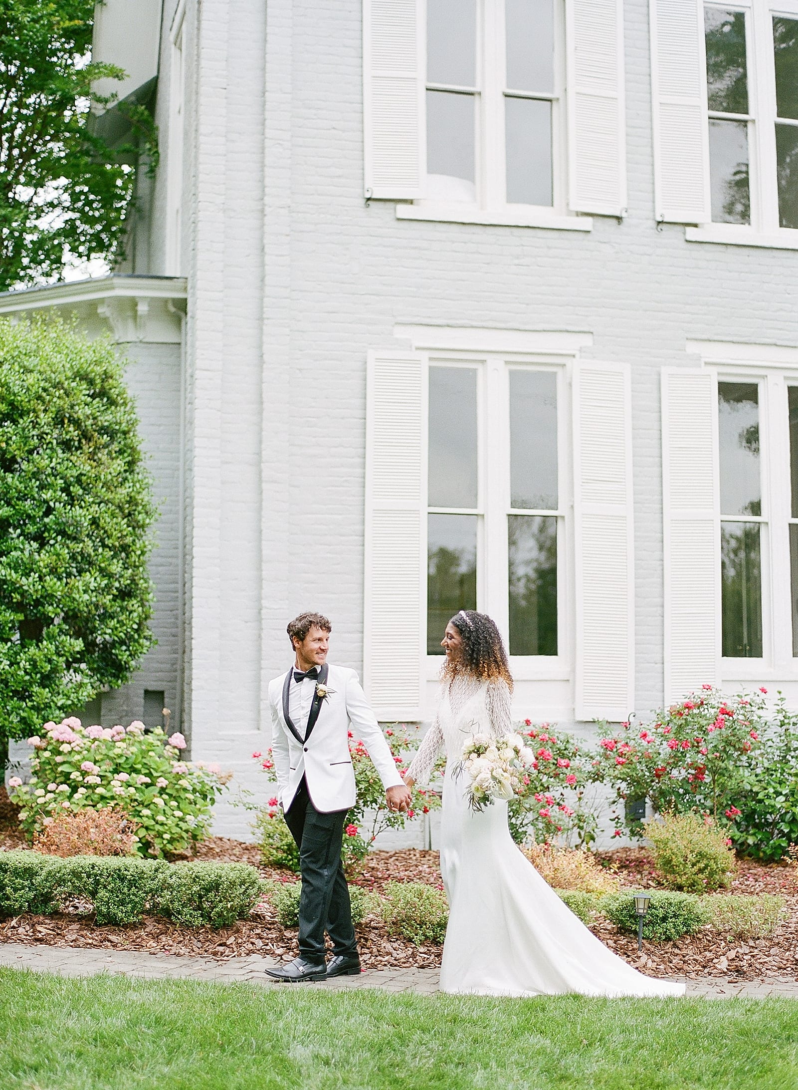 Greensboro NC Wedding Venues Bride and Groom Walking Holding Hands Photo