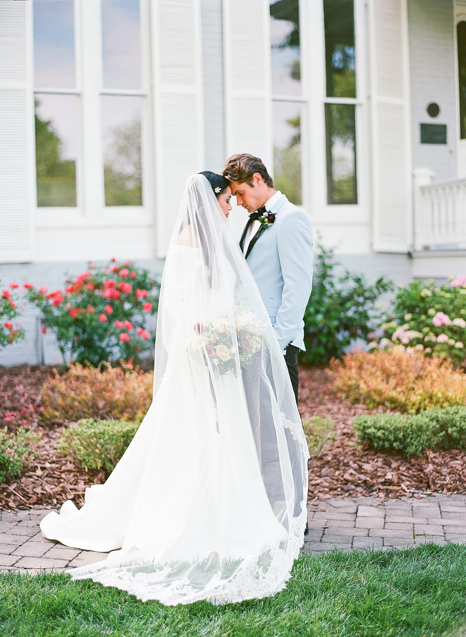 McAlister Leftwich House Wedding Bride and Groom Snuggling with Veil Sweeping in Front Photo