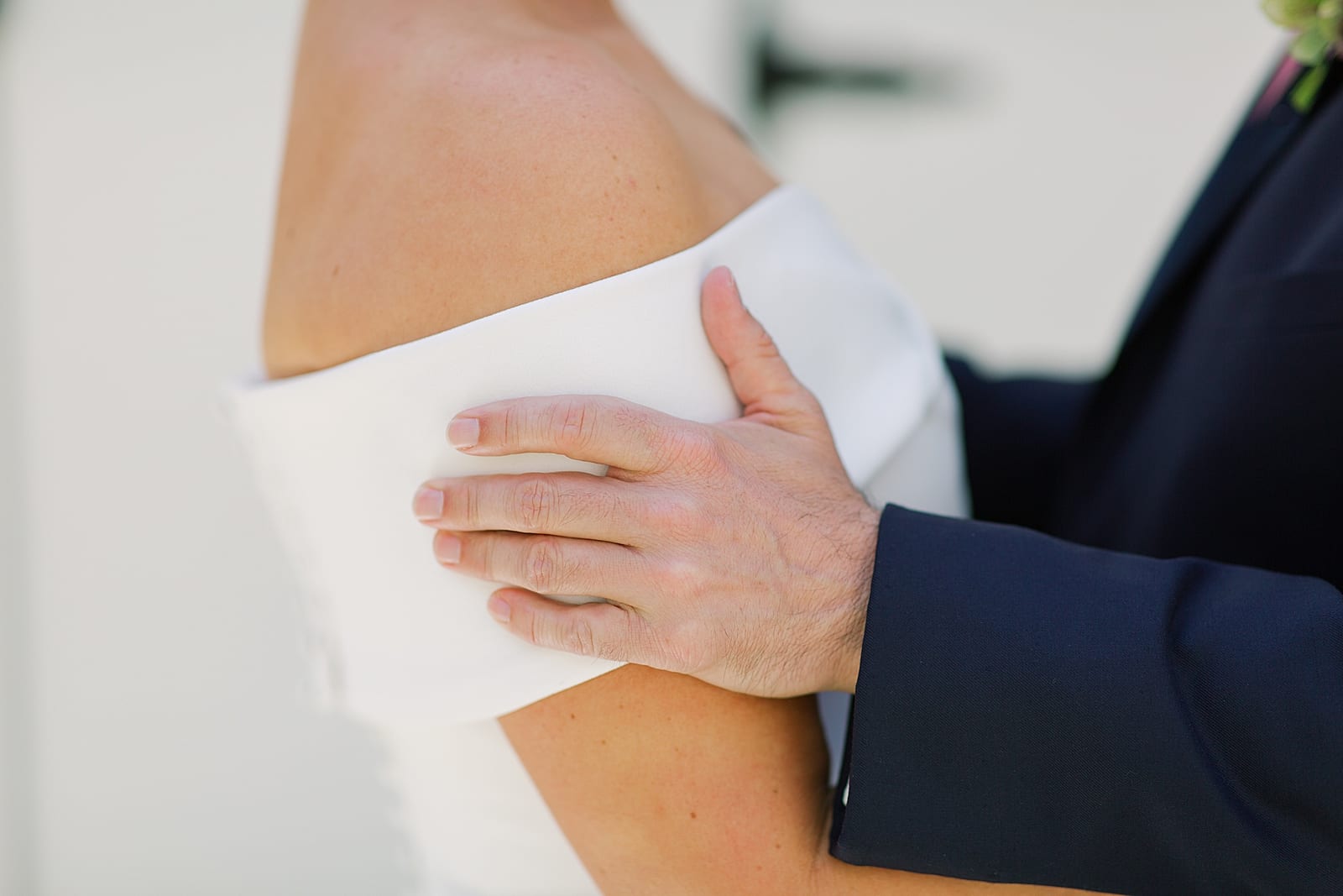 Grooms Hand On Brides Arm Photo