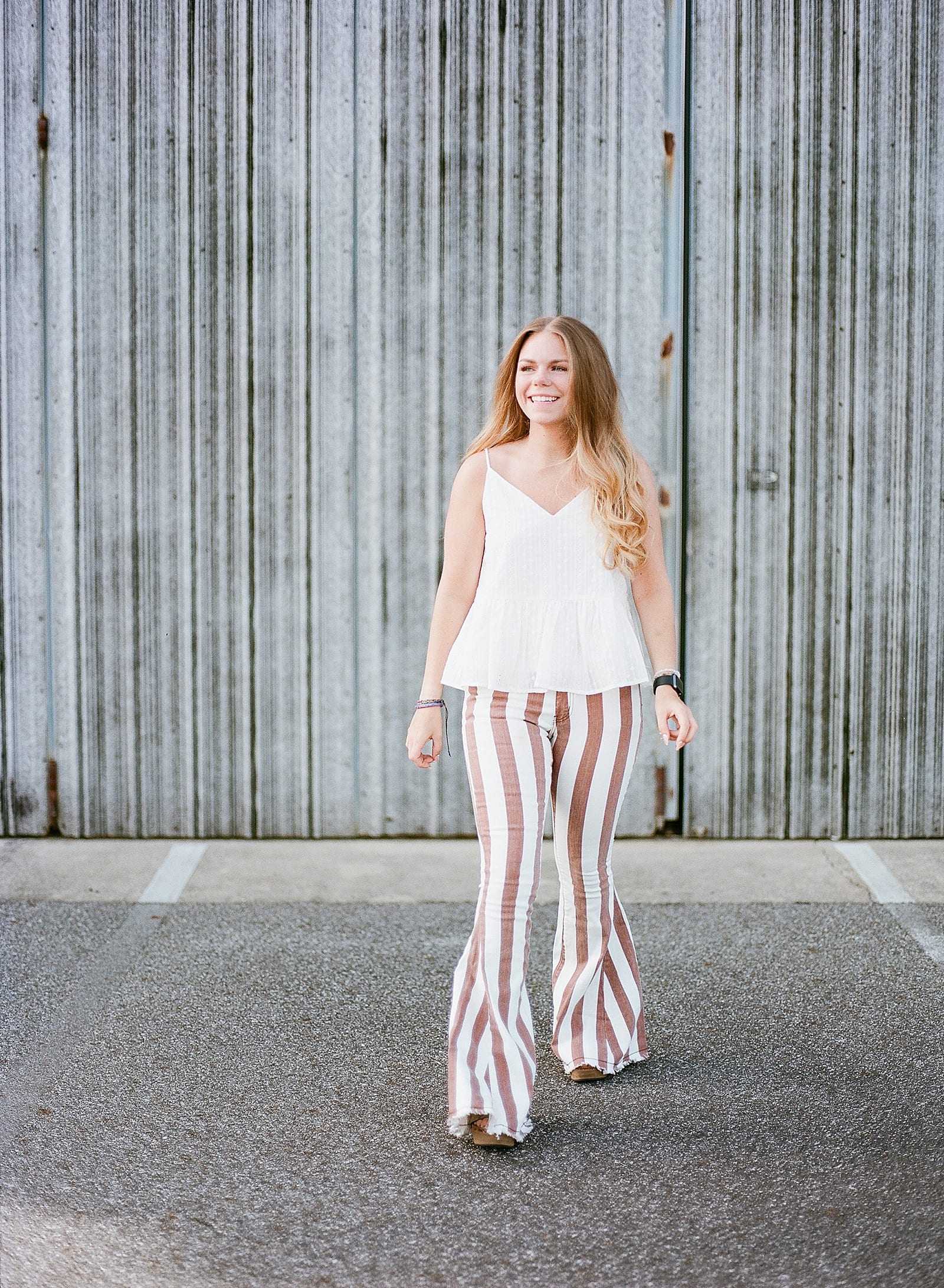 Asheville Senior Photos Girl in front of airplane hanger with striped pants Photo