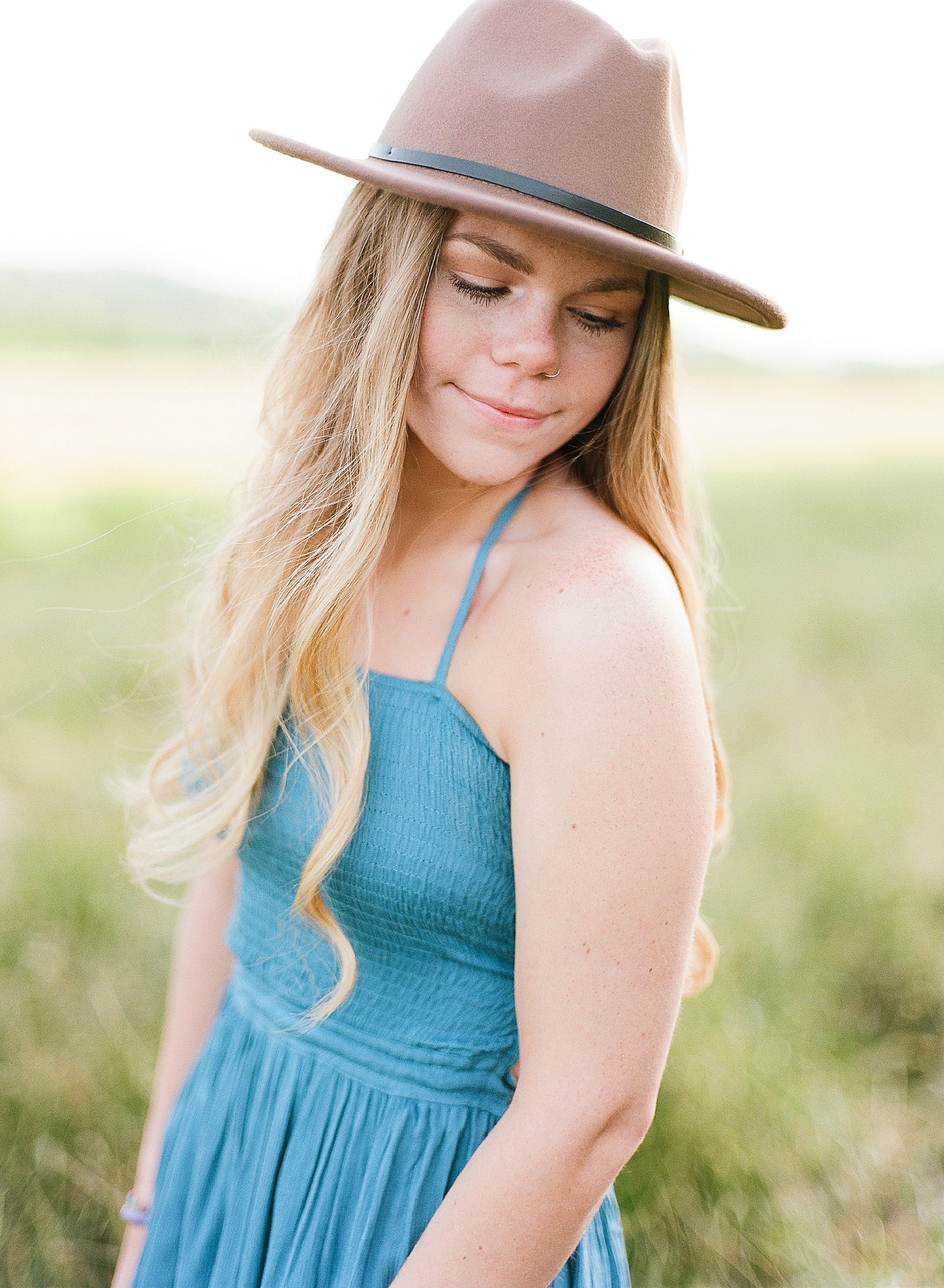 Asheville Senior Photos girl in blue dress and hat looking over her shoulder photo