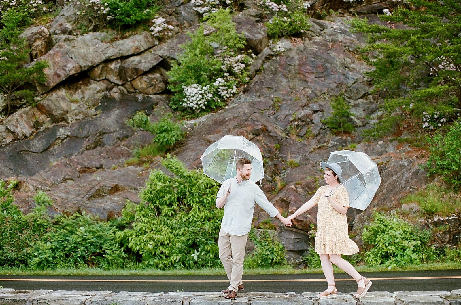 Couple walking with umbrellas Photo