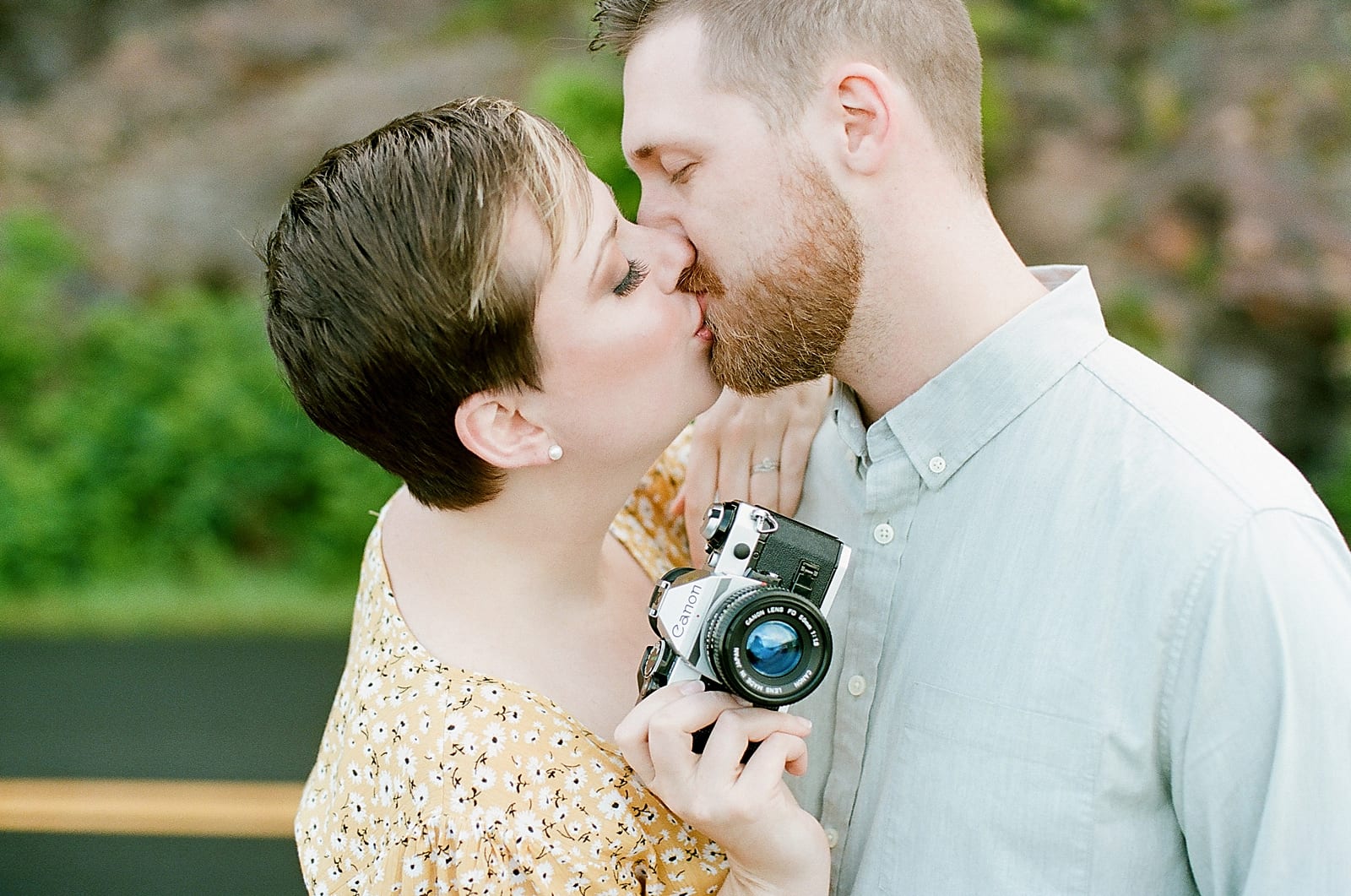 Couple Kissing Girl Holding Camera Photo