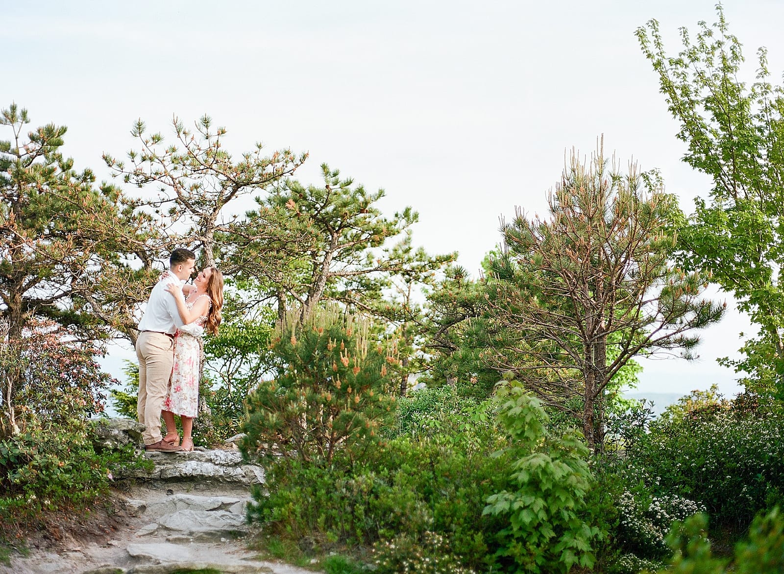 Hawksbill Mountain NC Couple Hugging on Rocks In The Trees Photo