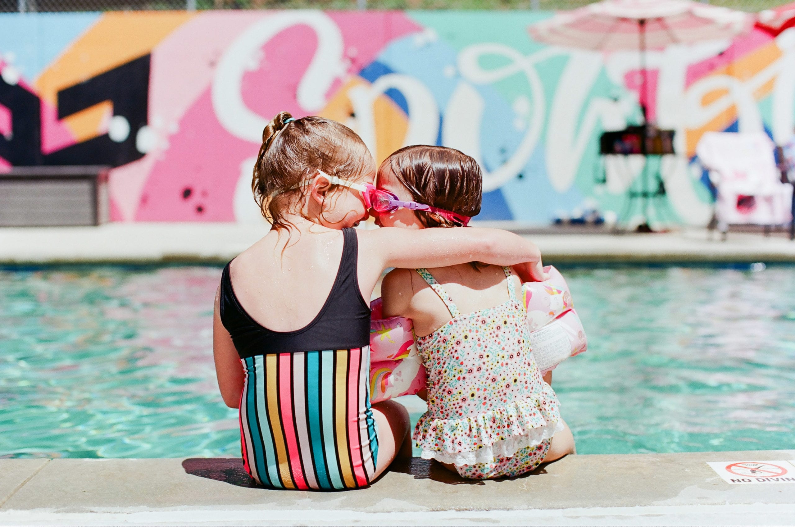 Kodak Ektar 100 little girls on edge of pool nose to nose photo