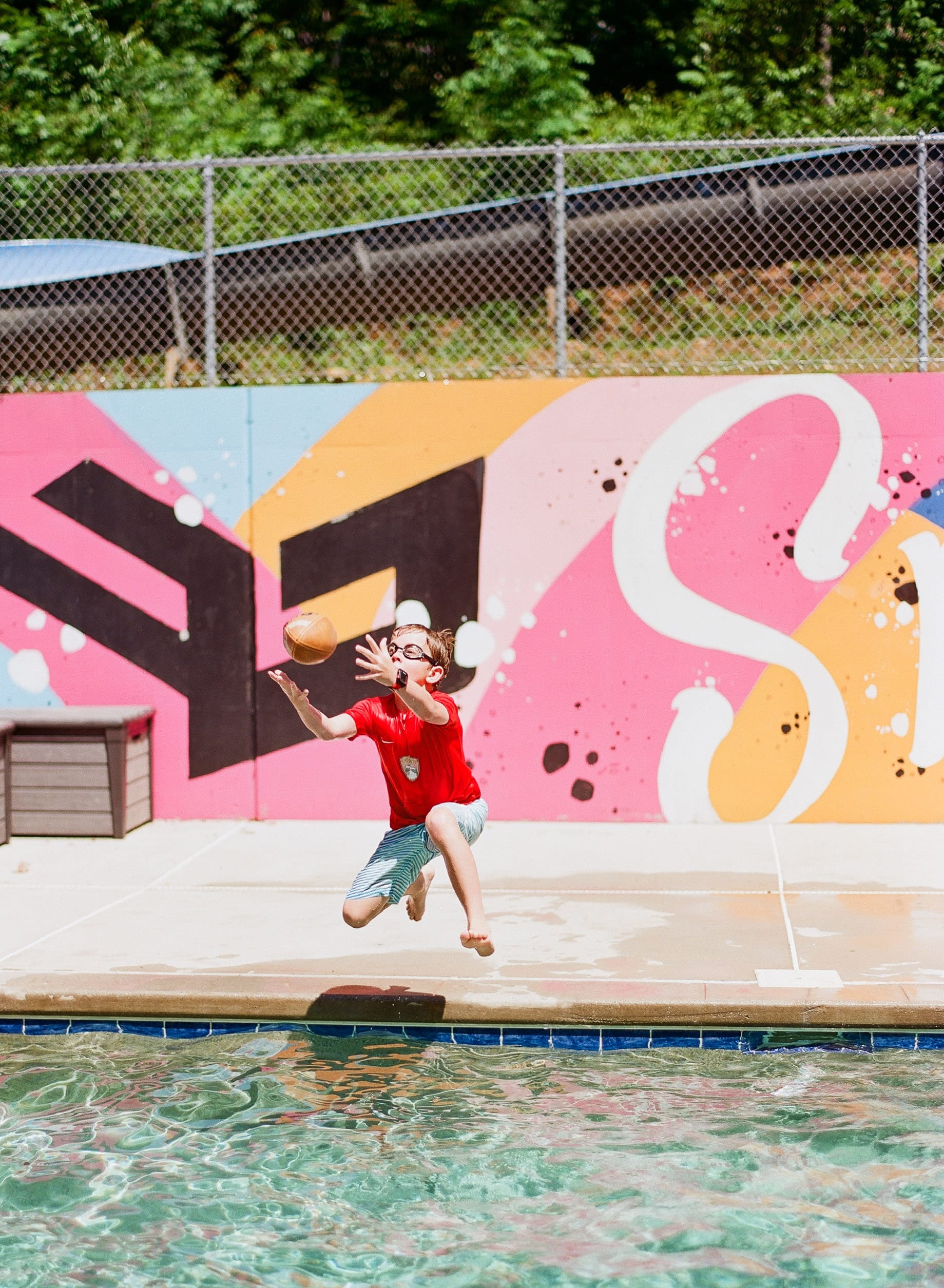 Kodak Ektar 100 kid jumping for football in pool photo