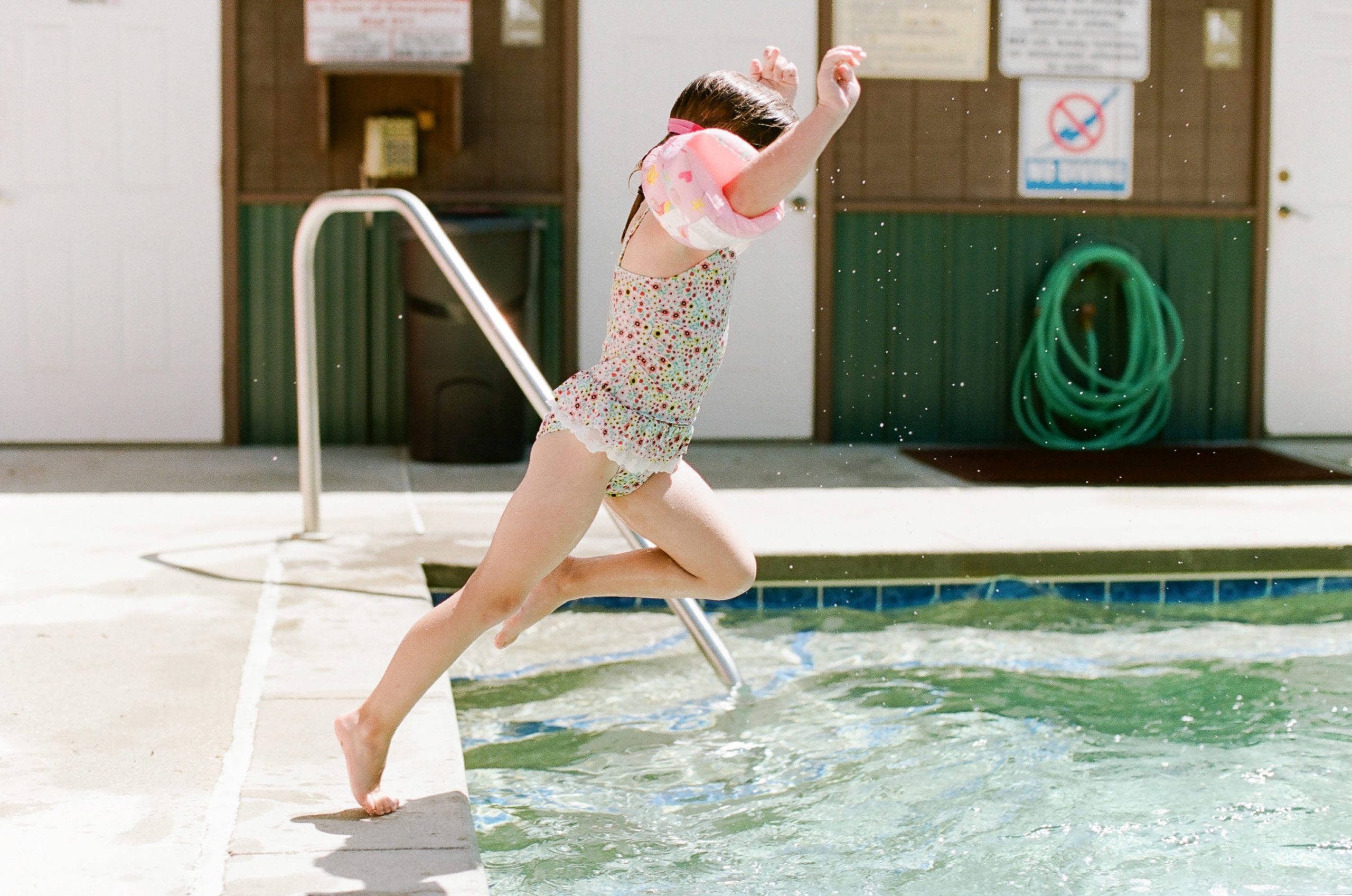 Portra 160 film of girl jumping in pool photo