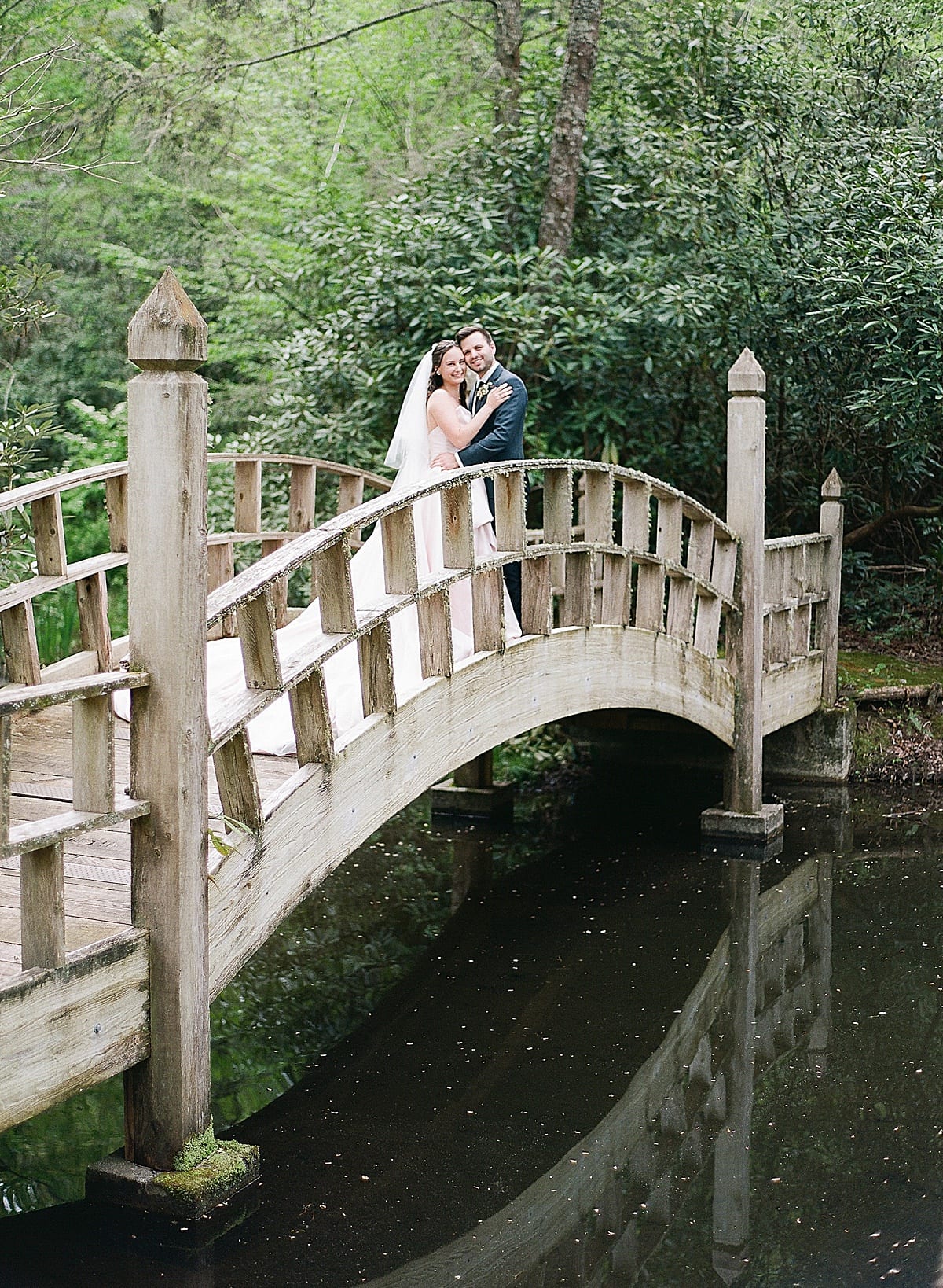 Bride and Groom on Bridge at Old Edwards Inn Photo