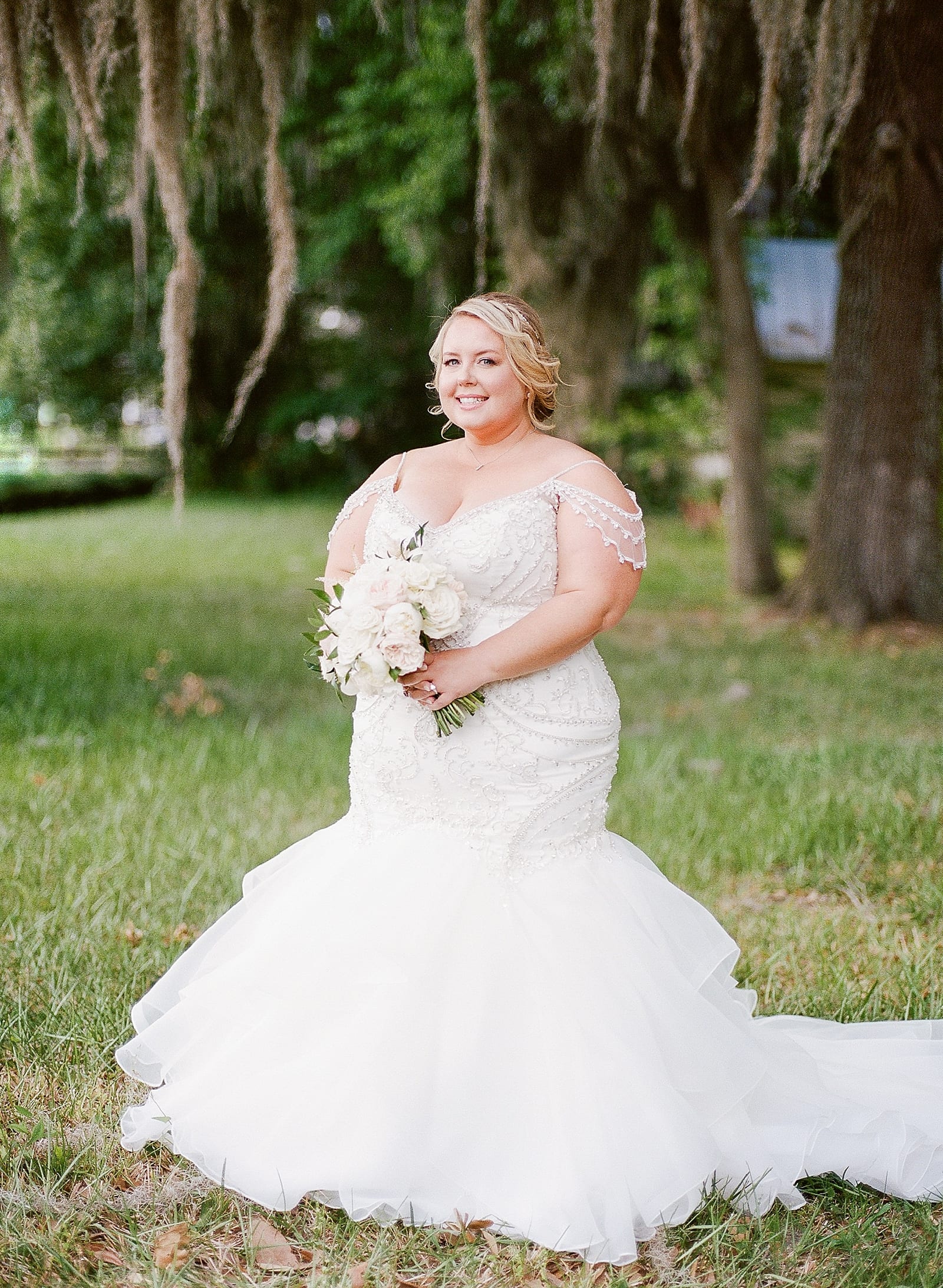 Bride Smiling at camera Holding Bouquet Photo