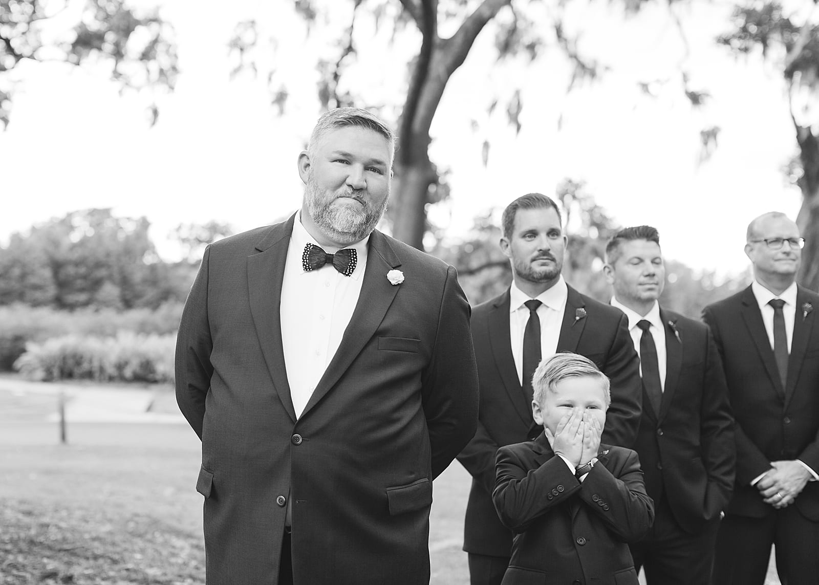 Black and White of Groom and Groomsmen Watching Bride Come Down the aisle Photo