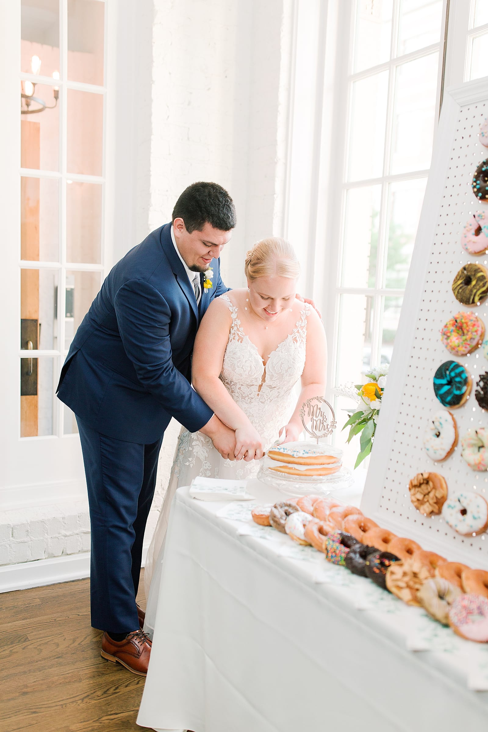 Bride and Groom Cutting Donut Cake Photo