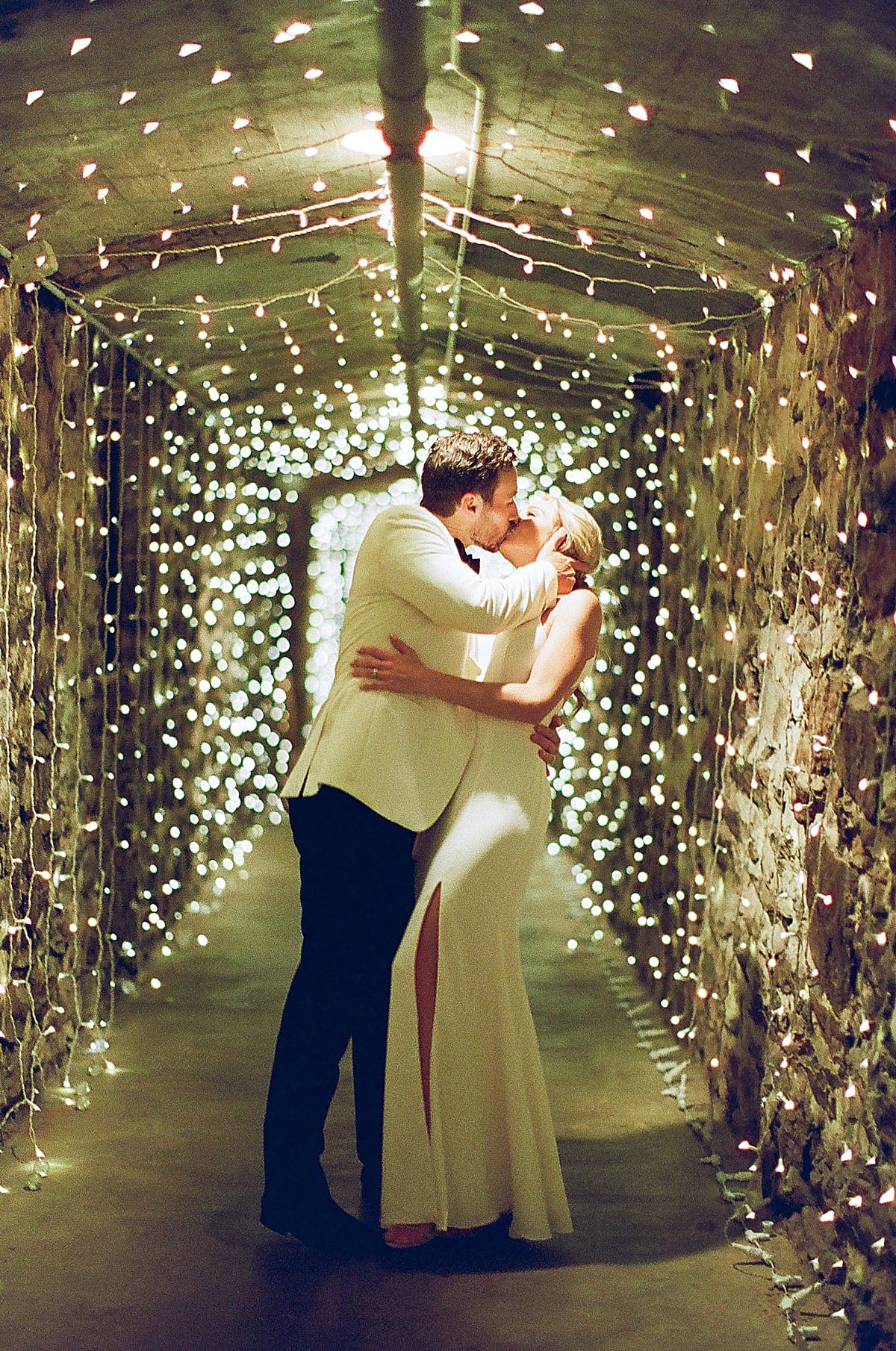 Biltmore Champagne Cellar Wedding Bride and Groom Kissing in Tunnel Photo