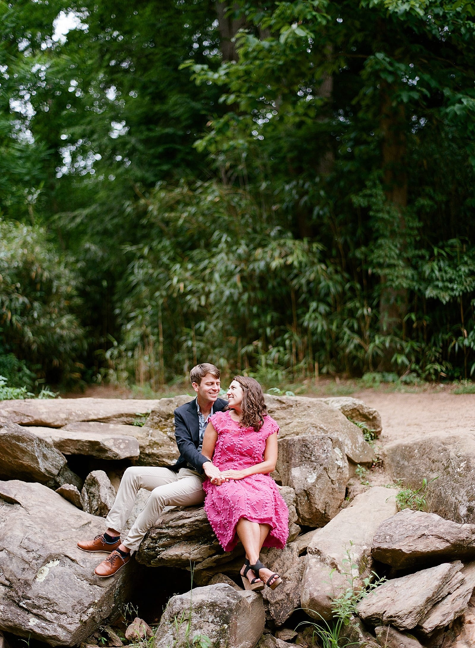 Romantic Biltmore Locations Couple On Rocks Smiling at Each Other Photo
