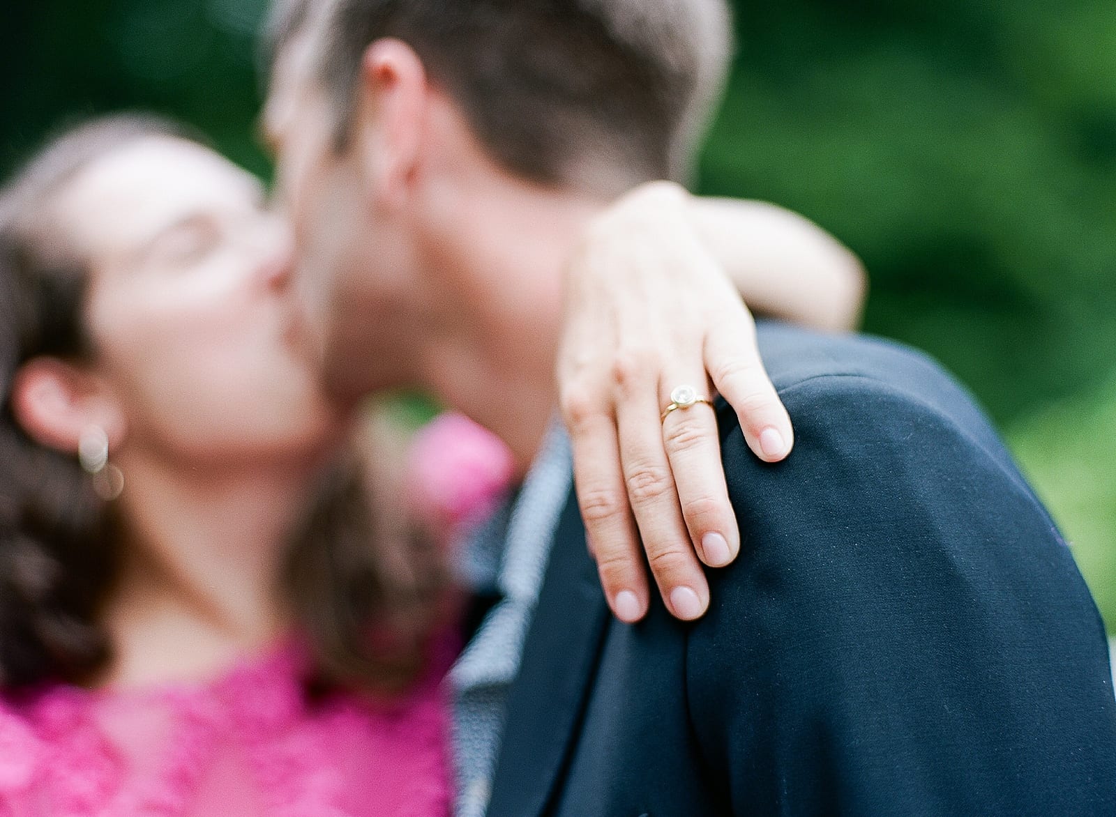 Couple Kissing With Her Ring Hand on His Shoulder Photo