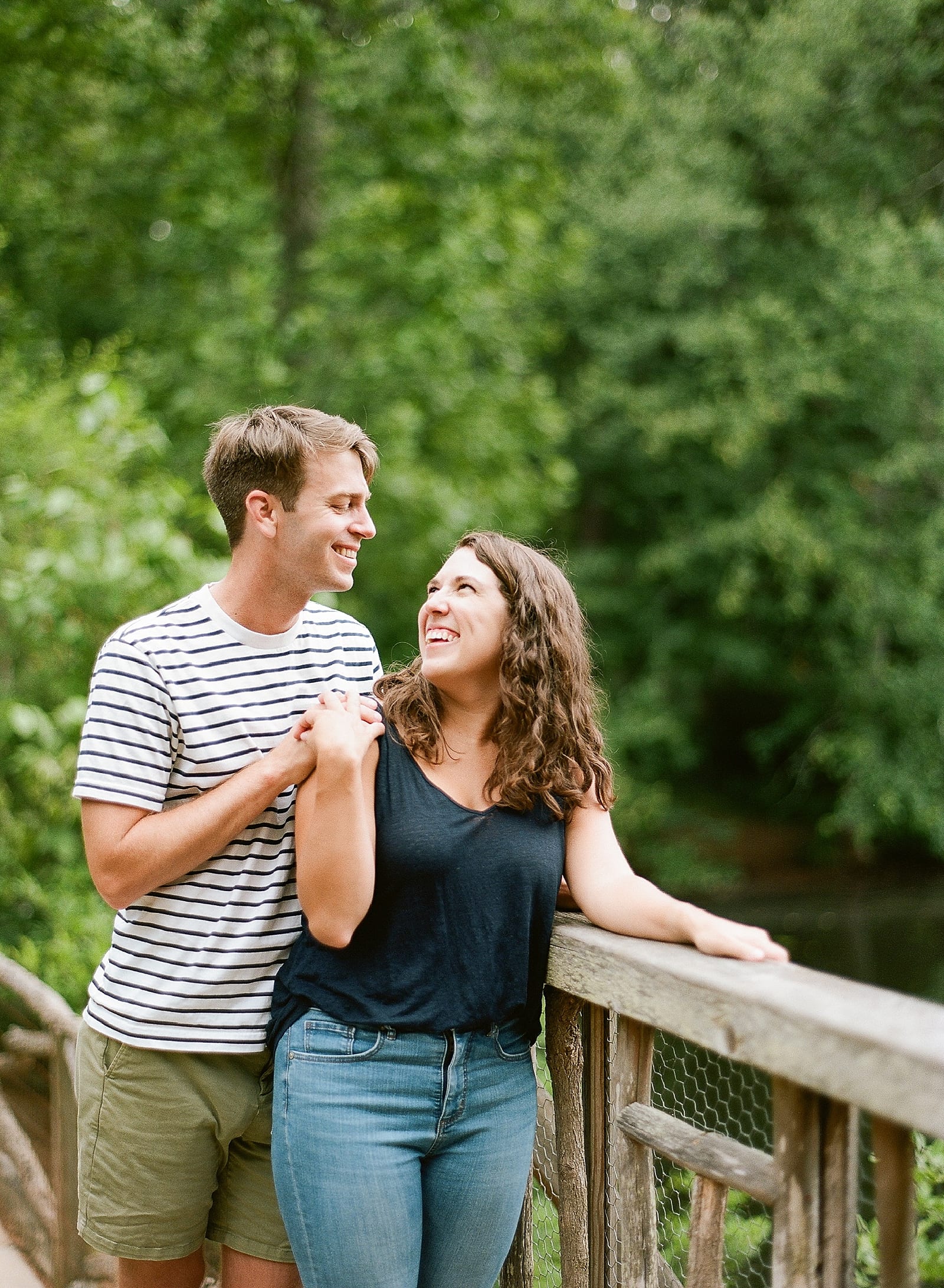 Couple Smiling at Each Other On Bridge at Bass Pond at Romantic Biltmore Photo